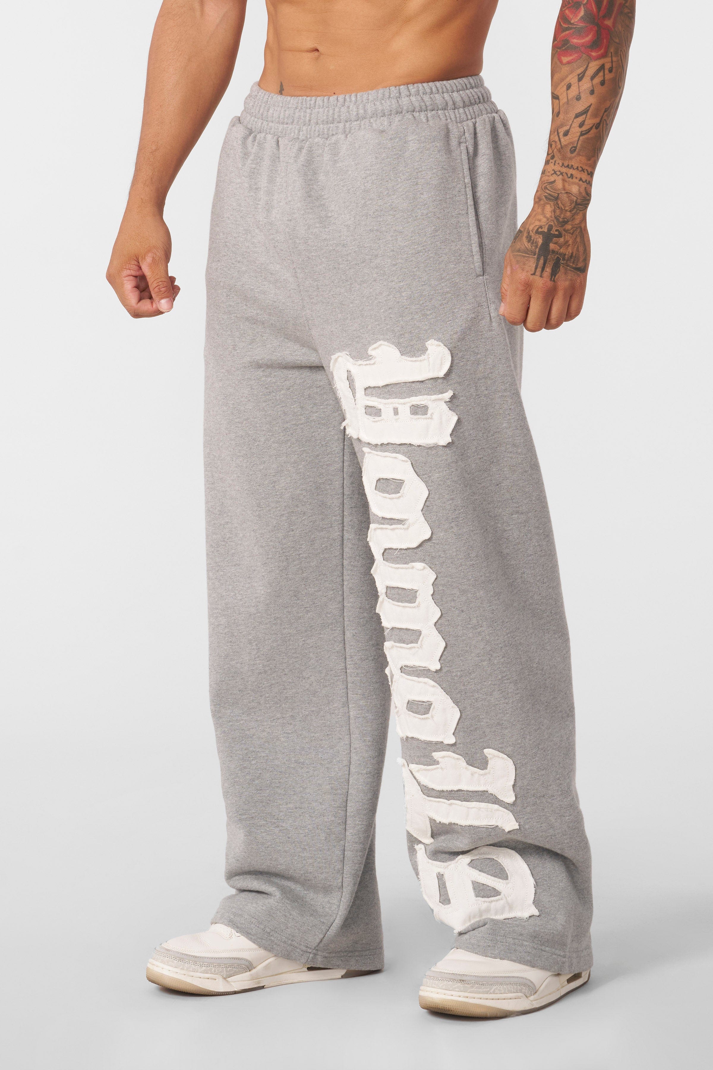 Front view of mens baggy sweatpants with logo patch