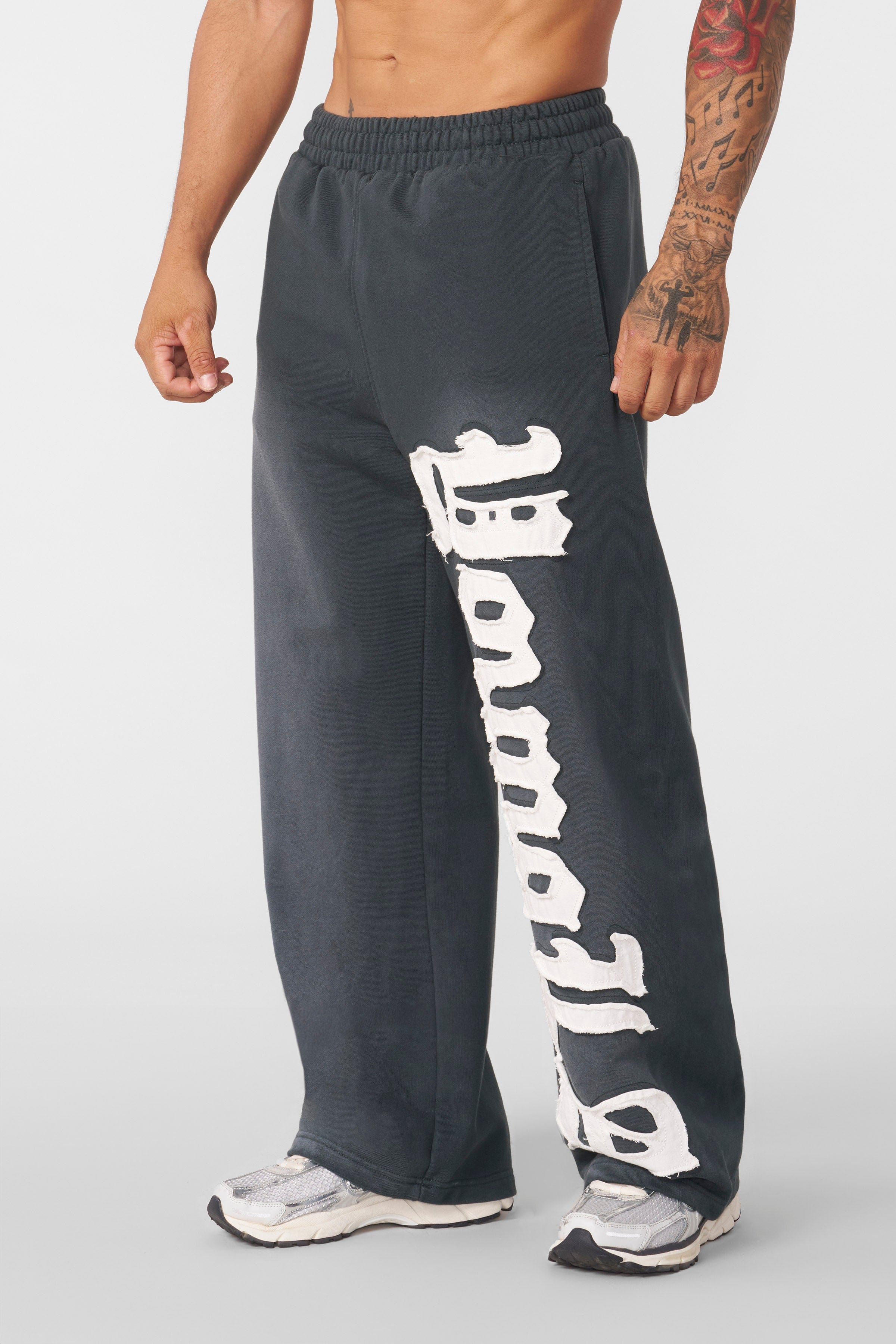 Close-up of the sprayed-wash finish on baggy joggers