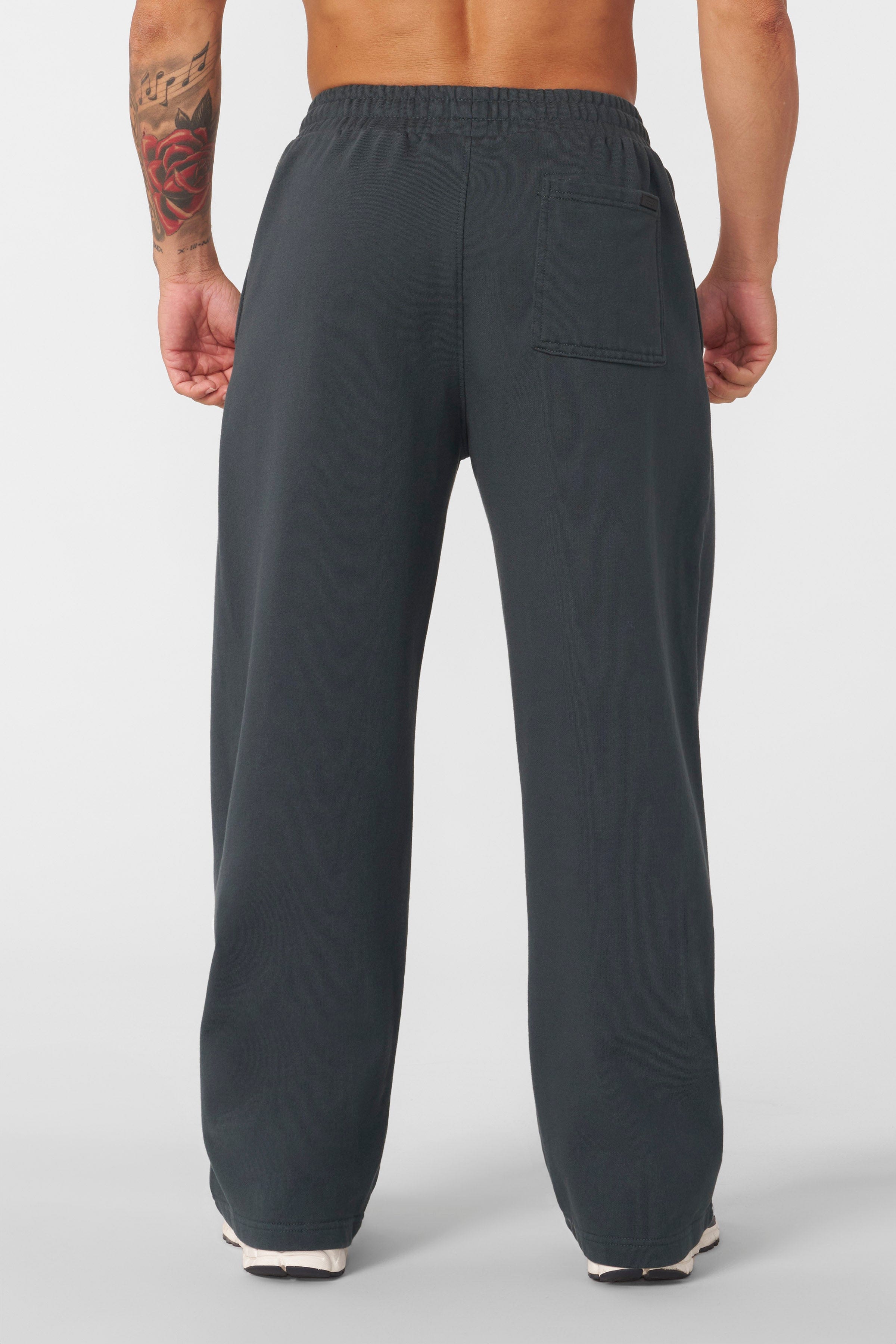 Close-up of the sprayed-wash finish on baggy joggers