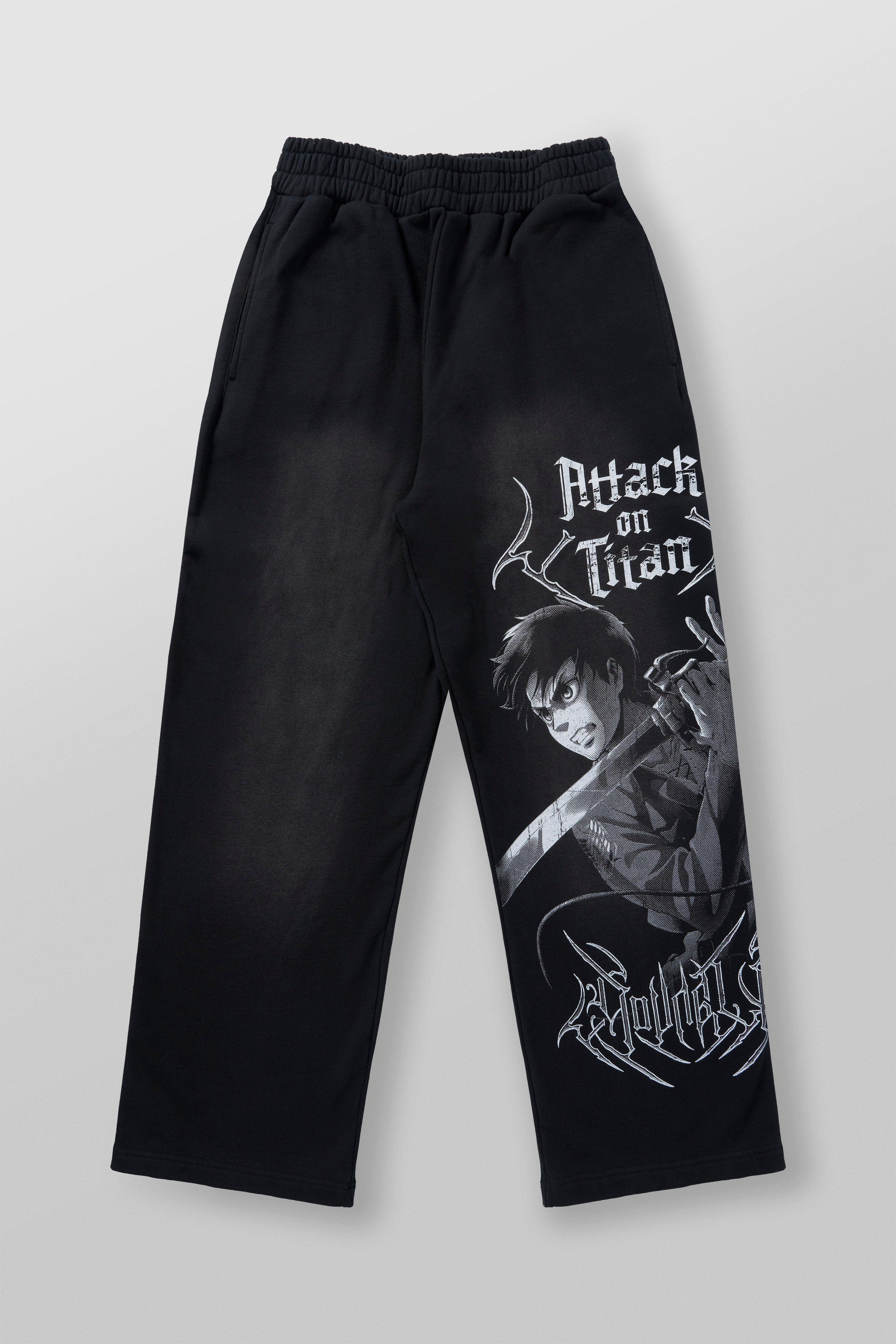 Model wearing black baggy joggers in an urban setting, embodying anime streetwear style.