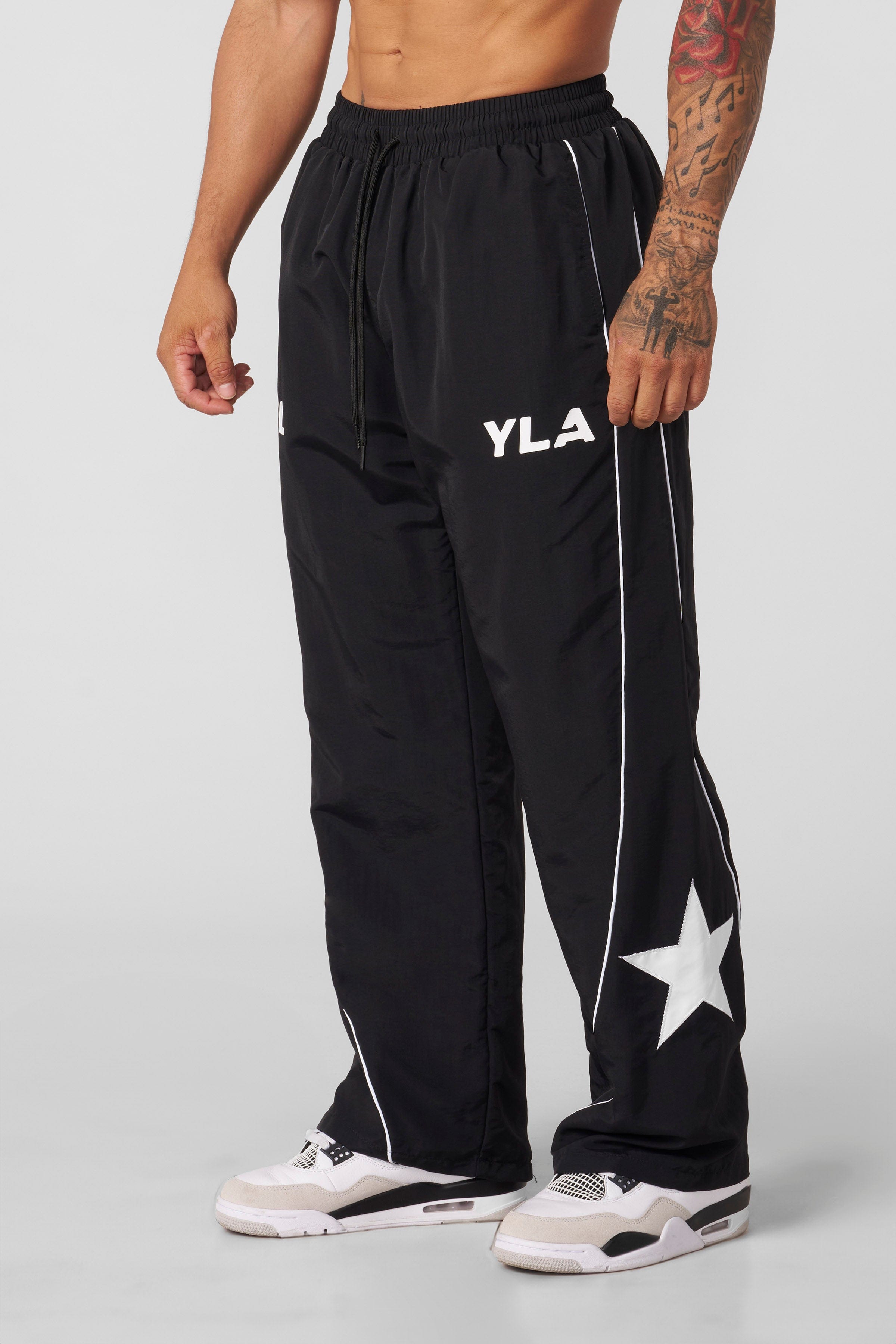 Close-up of the fabric and design details of the tracksuit pants