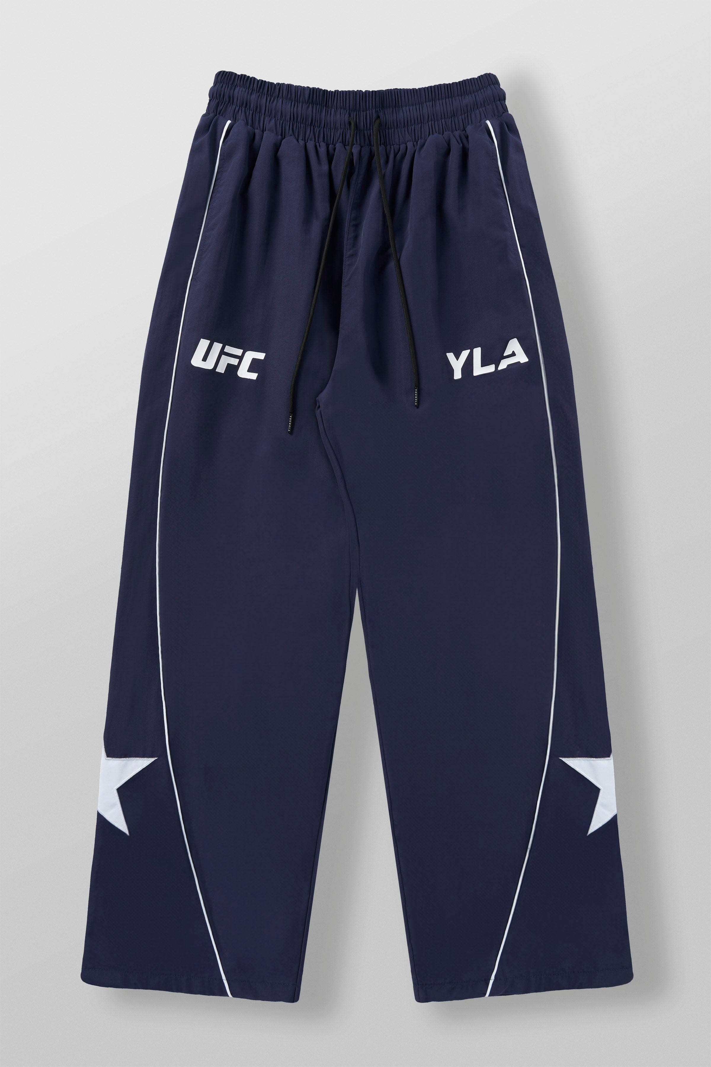 Front view of YoungLA x UFC tracksuit pants showcasing side piping and star patch