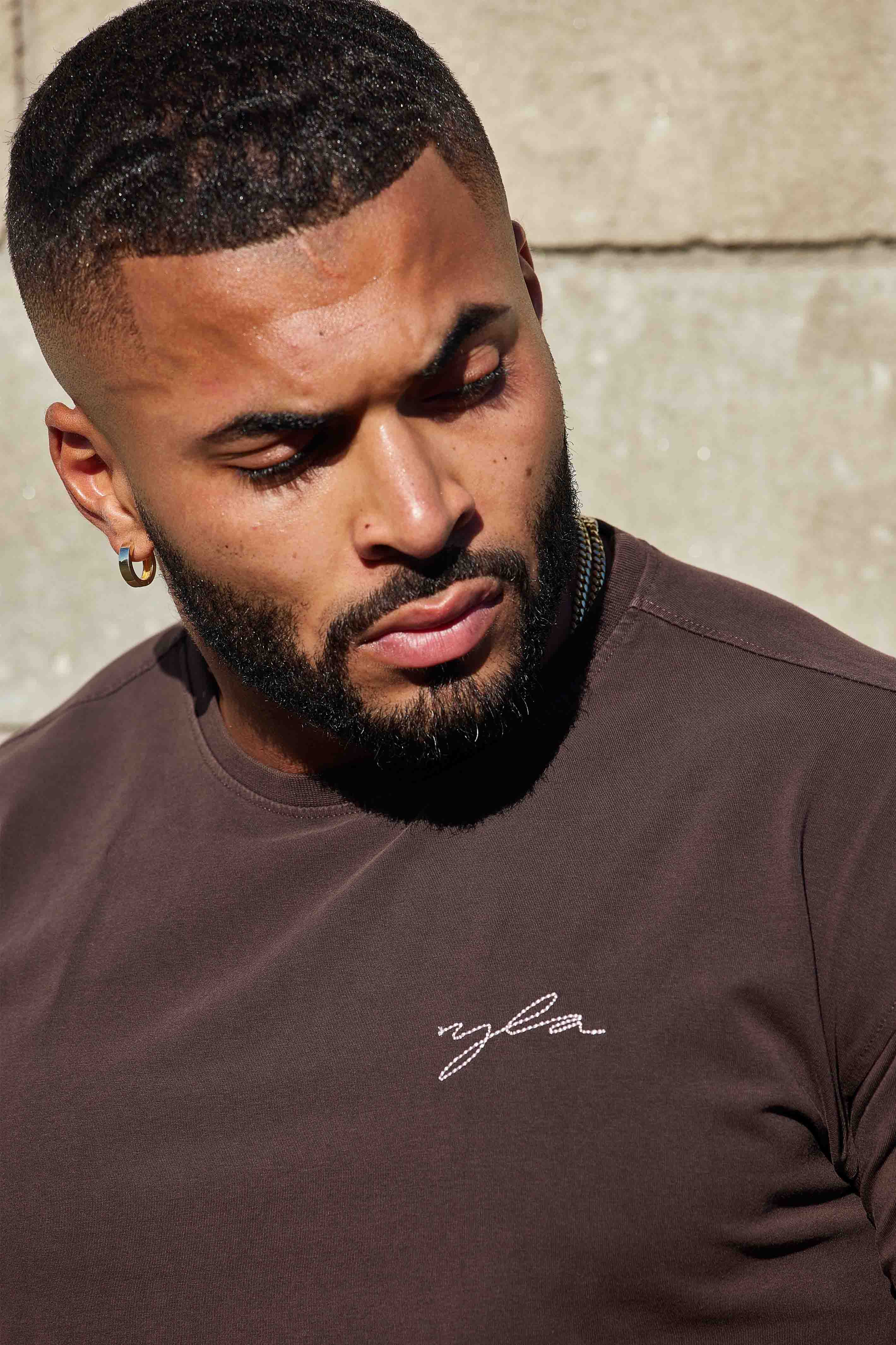 Front view of the slim fit t shirt on model, styled for fall layering