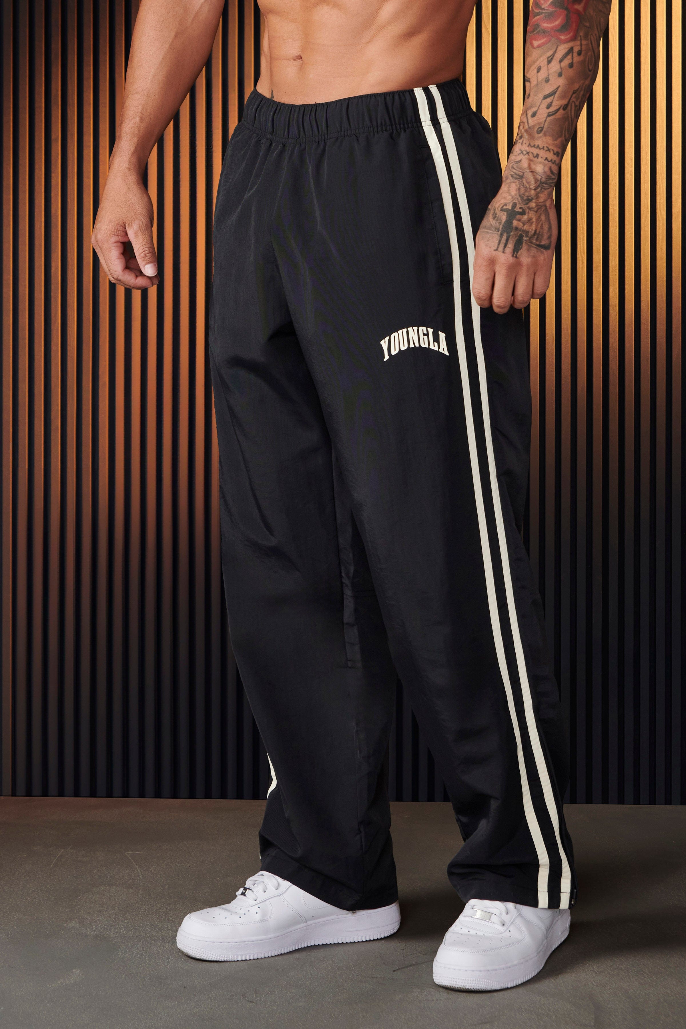 Model wearing black joggers, perfect for casual outings or lounging.