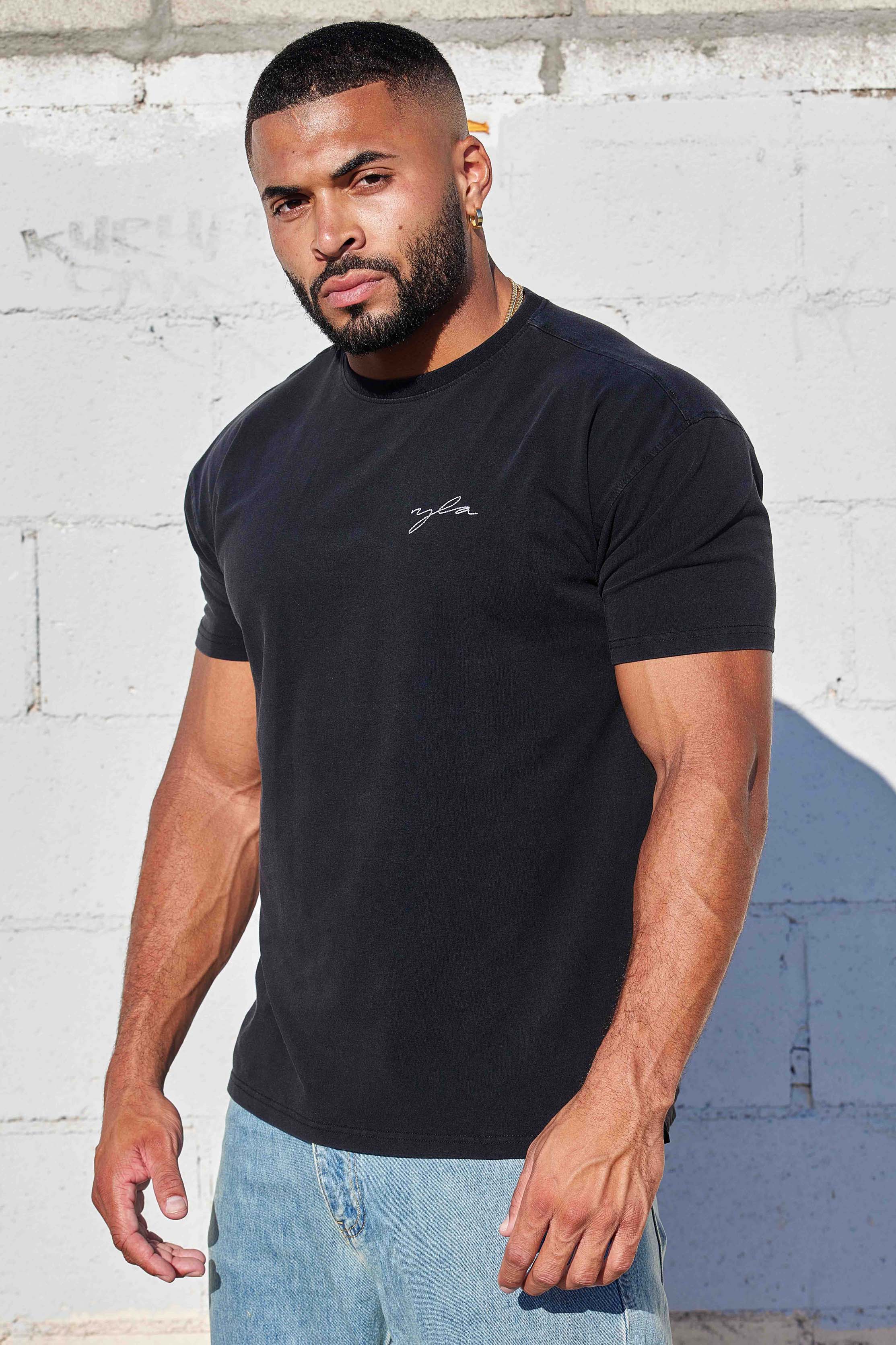 Front view of the slim fit t shirt on model, styled for fall layering