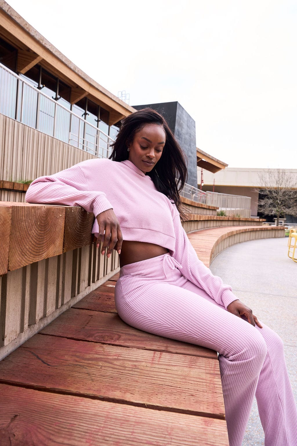 Flat lay of crop top hoodie styled with jeans and sneakers