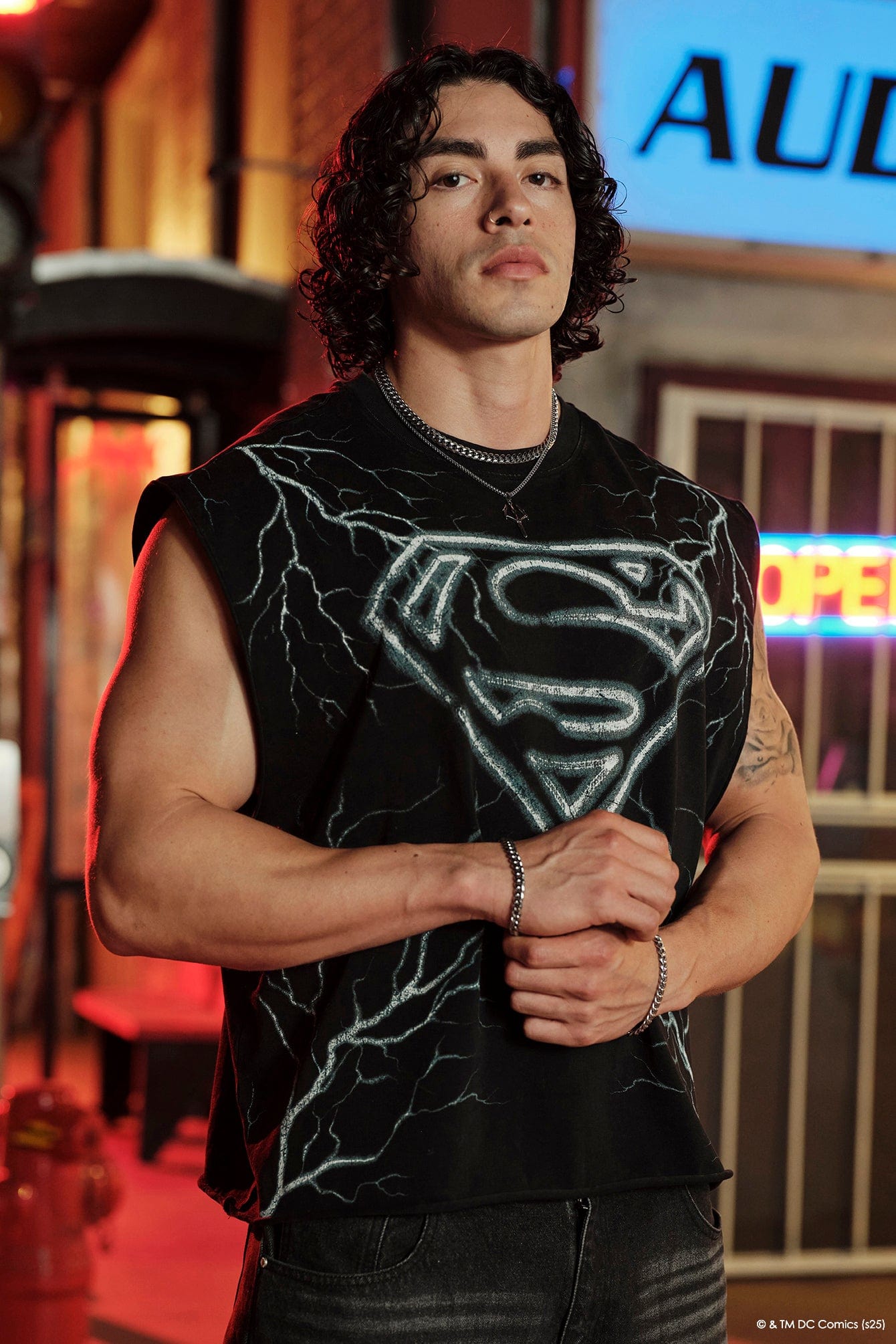 Model wearing Superman workout tank top during an exercise session.
