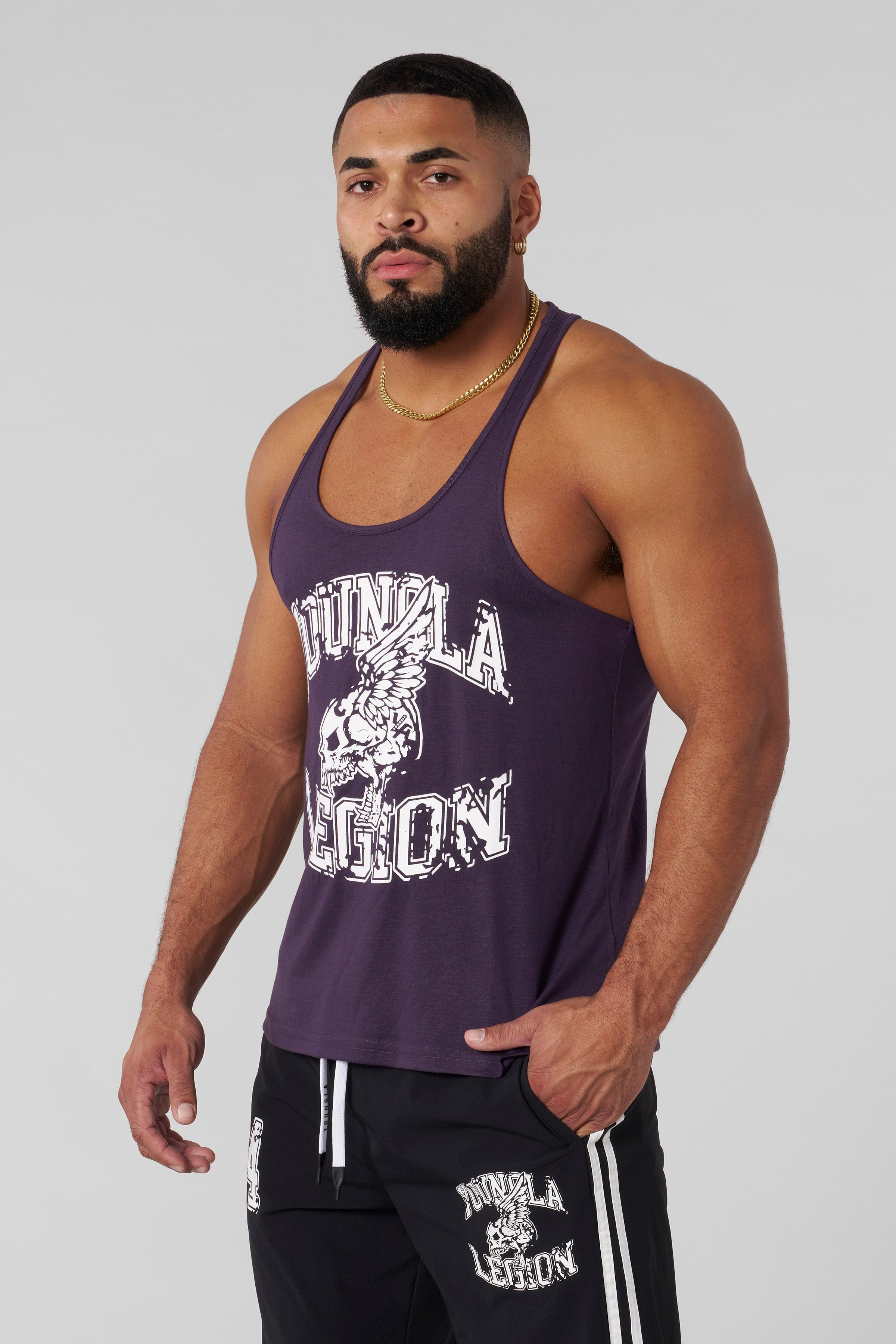 Model wearing Legion performance gym stringer in a workout setting.