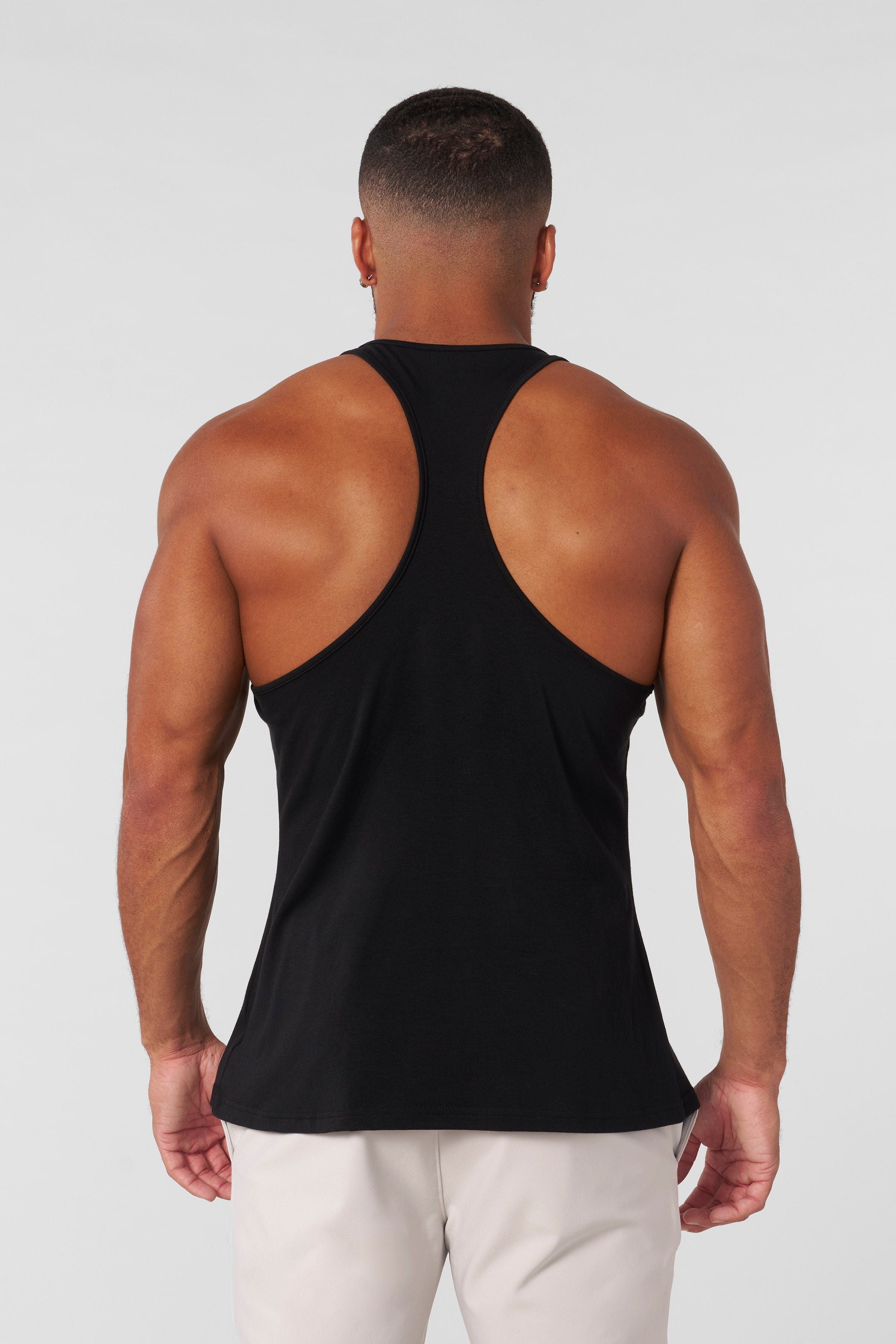 Back view highlighting the open design of the muscle tank top.