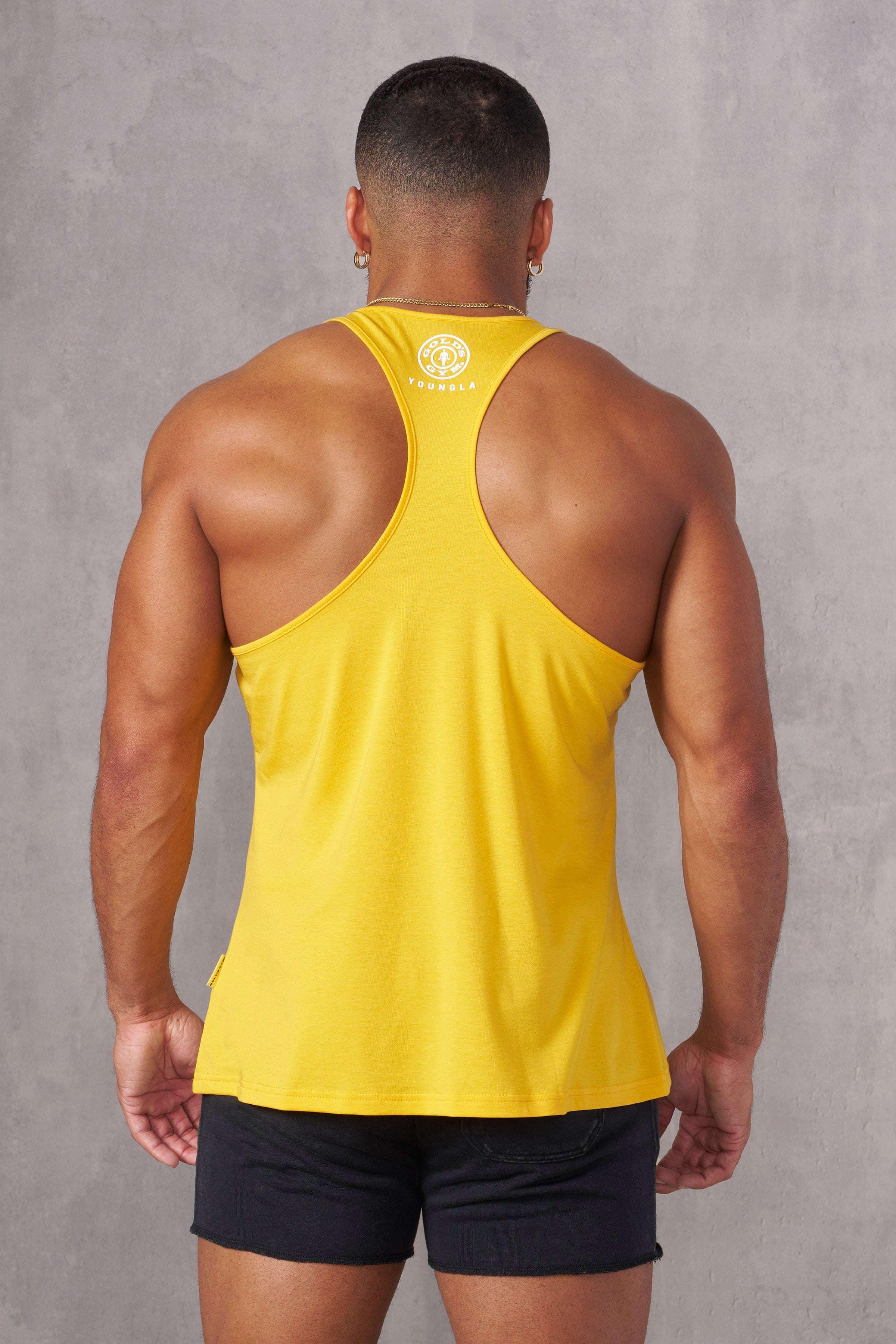 Side view of fitted tank top showcasing side seam branding.