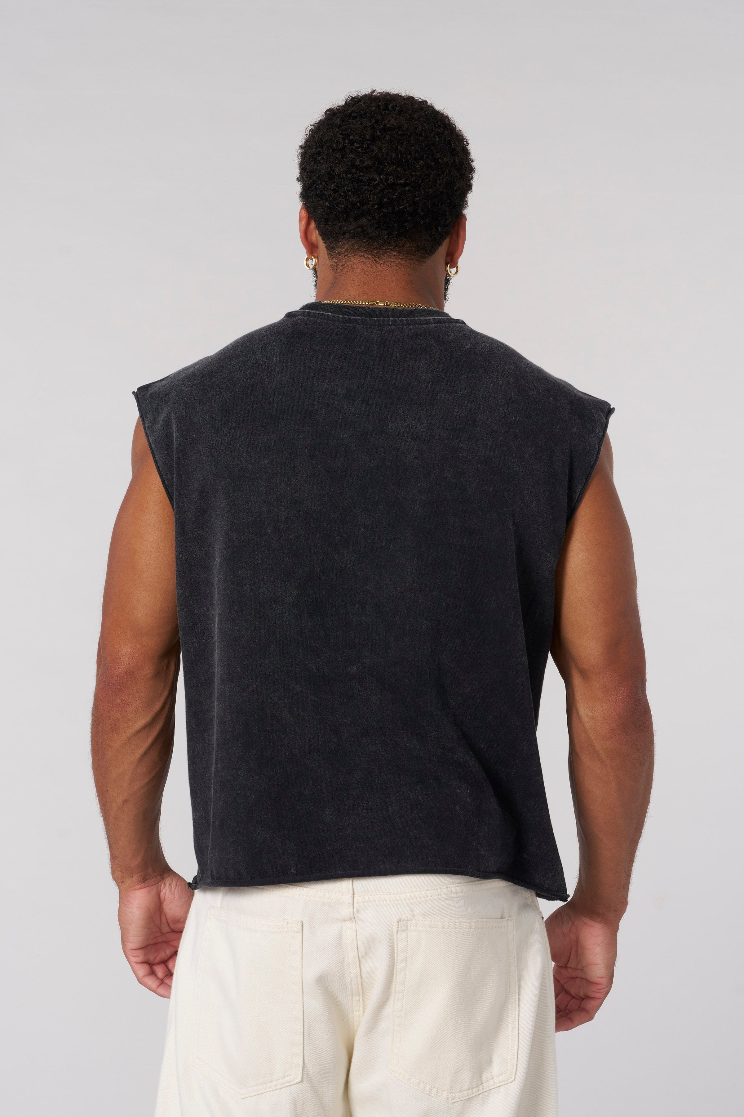 Front view of the Revenge Distressed Crop Tank Top showcasing the logo.