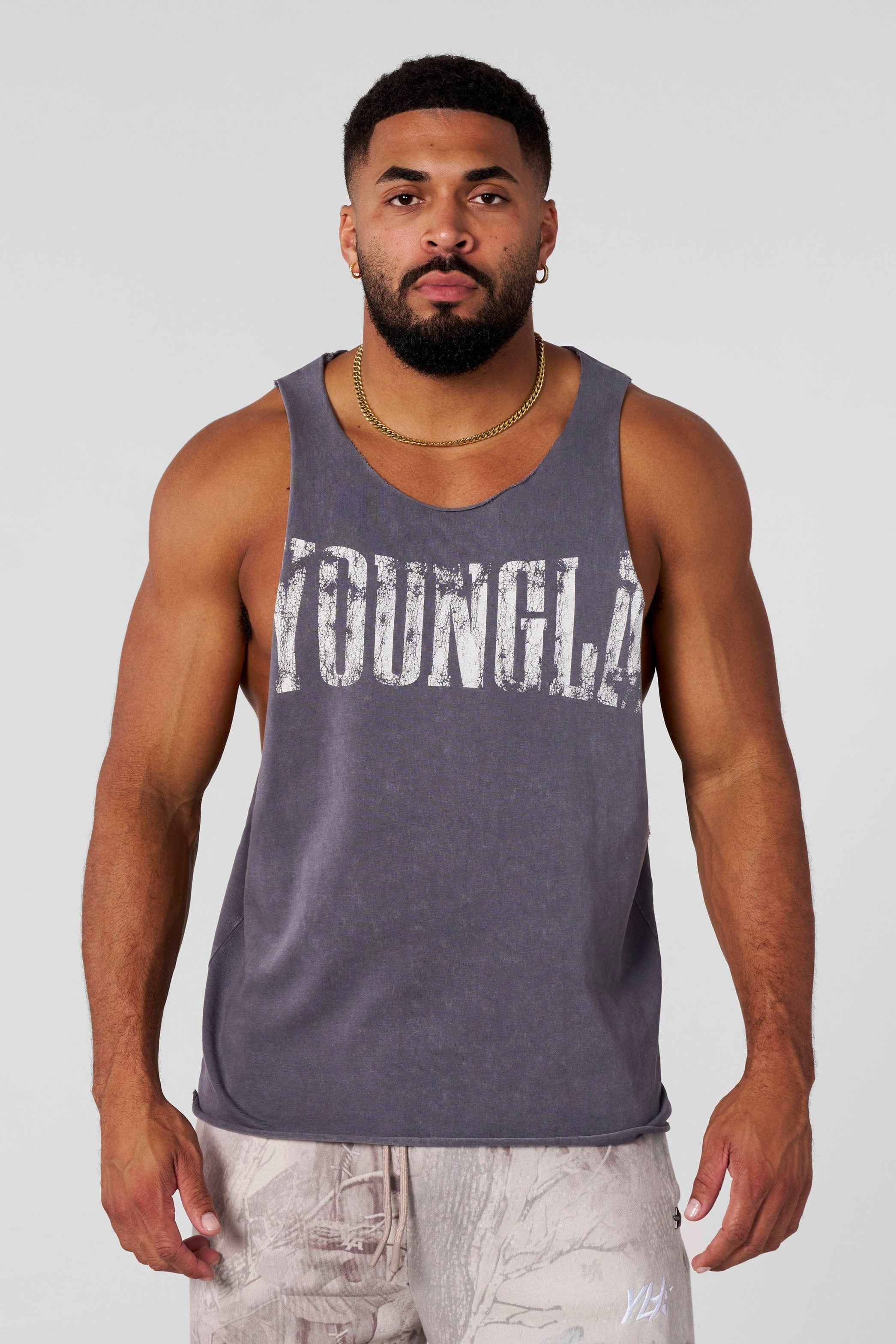 Side view of gym tank tops for men during delt exercises
