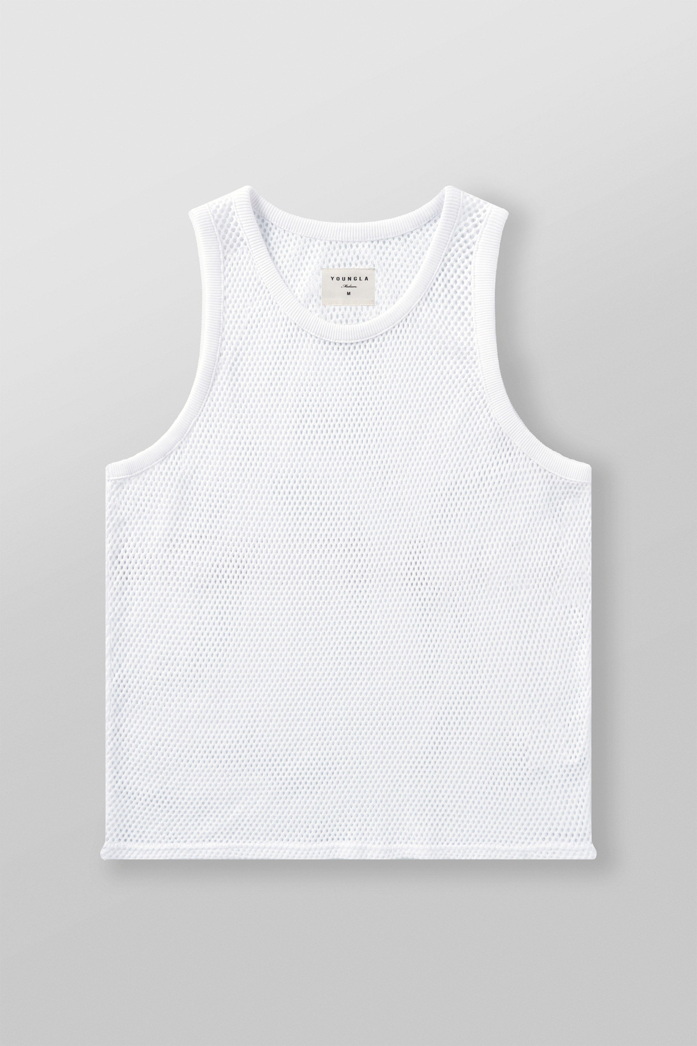 Male model wearing a mesh tank top on a sunny day.