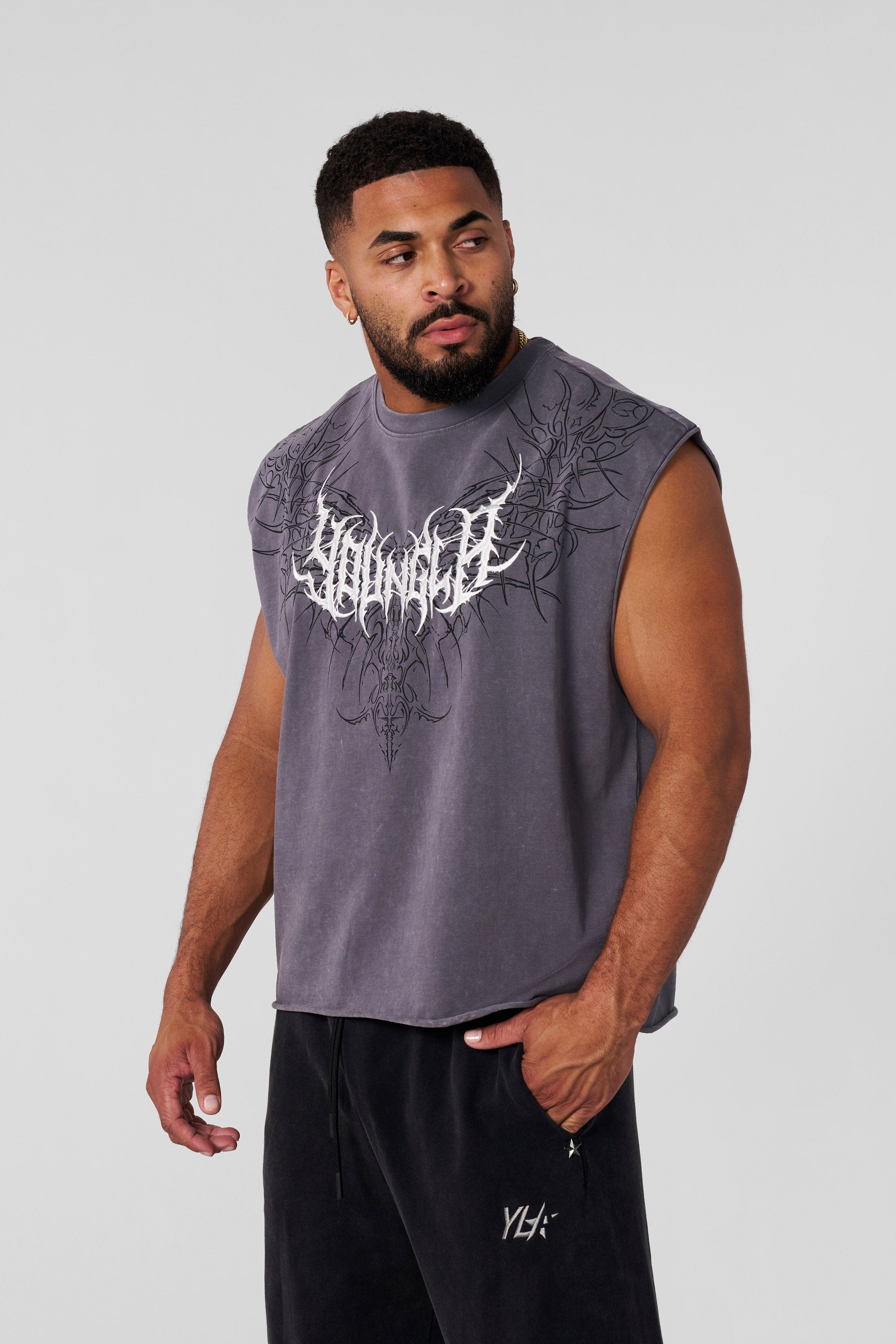 Close-up of the textured embroidery logo on the sleeveless shirt.