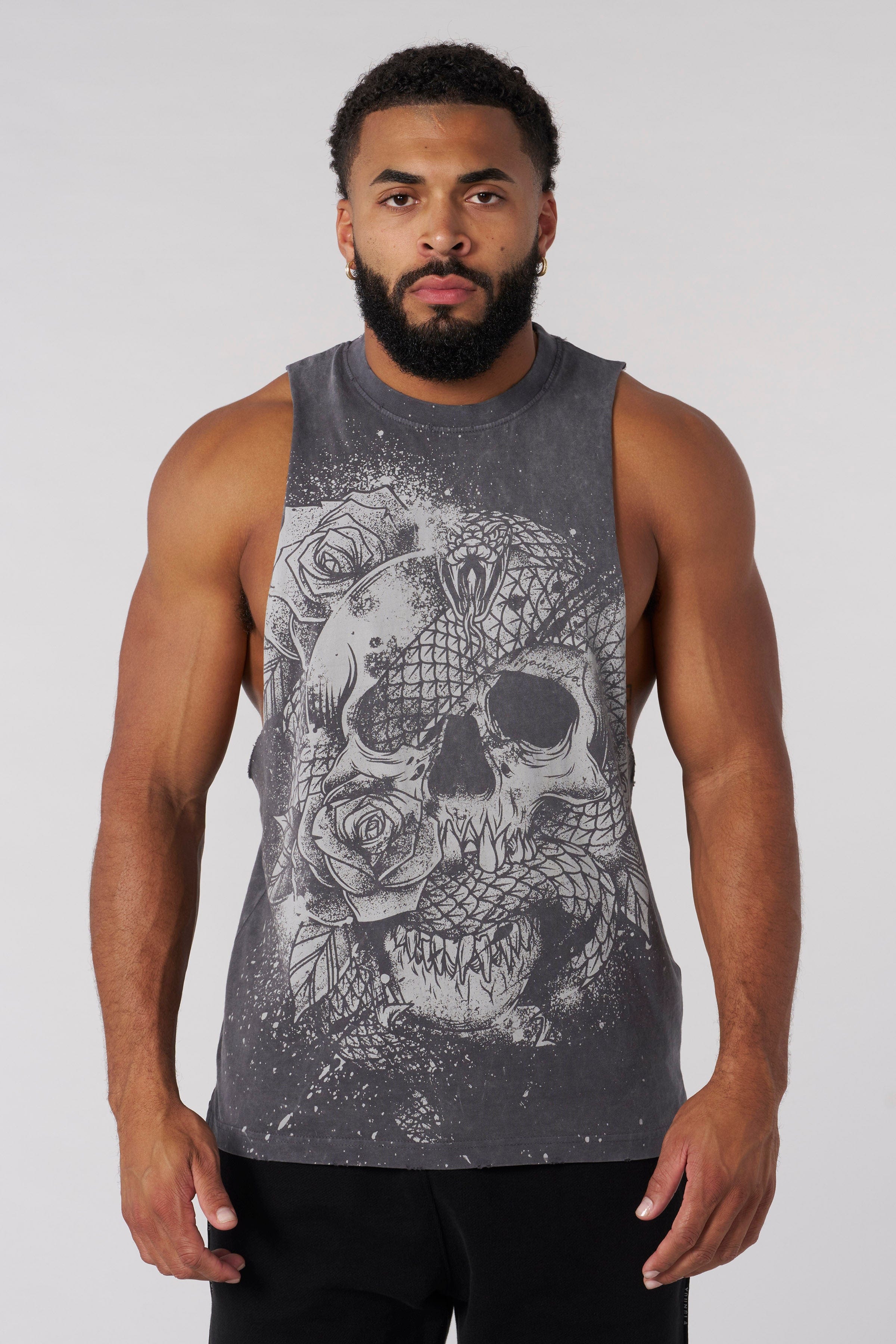 Front view of mens tank top in gym setting, showcasing bold graphics