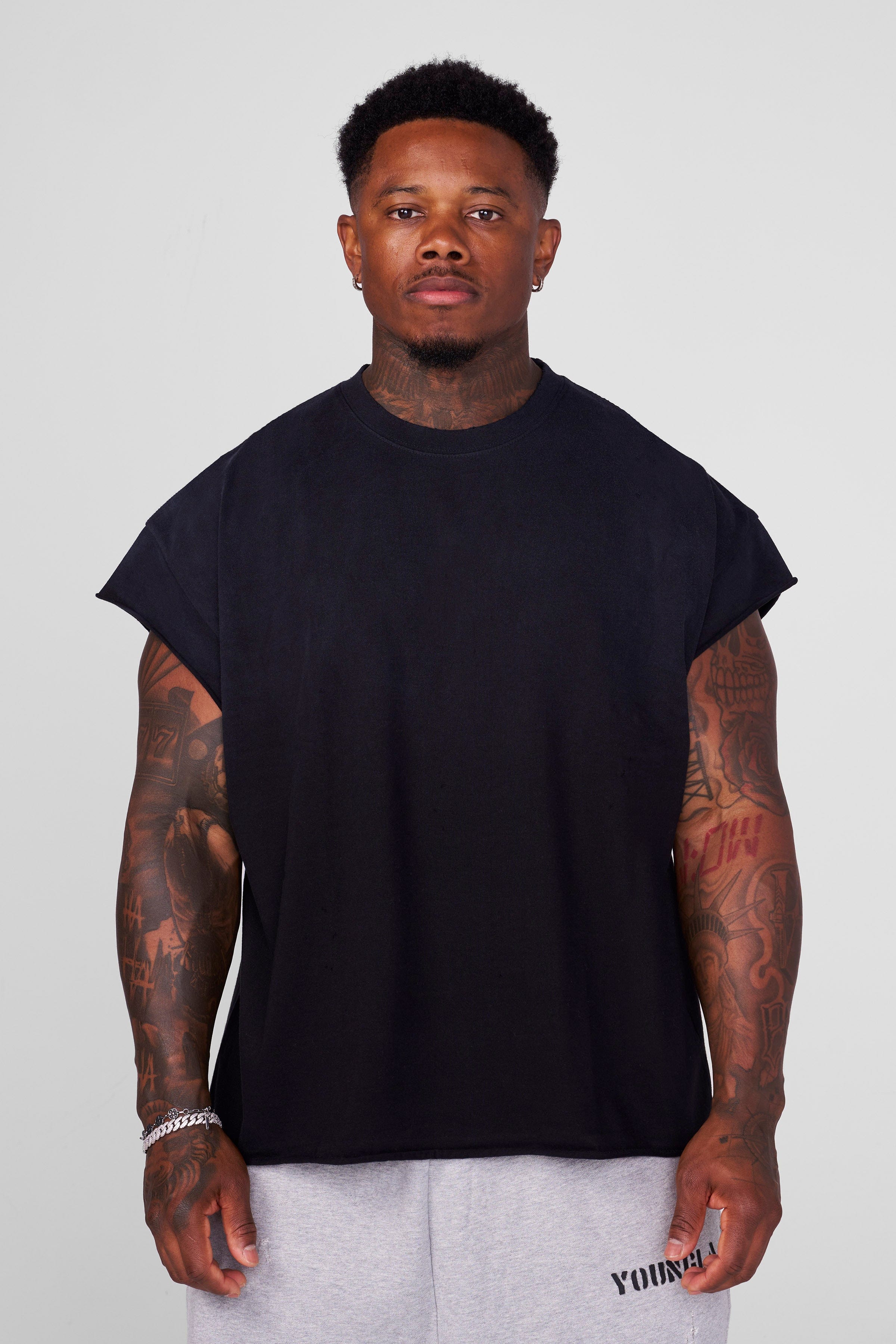 Washed black cut off tank displayed from side angle with YoungLA print