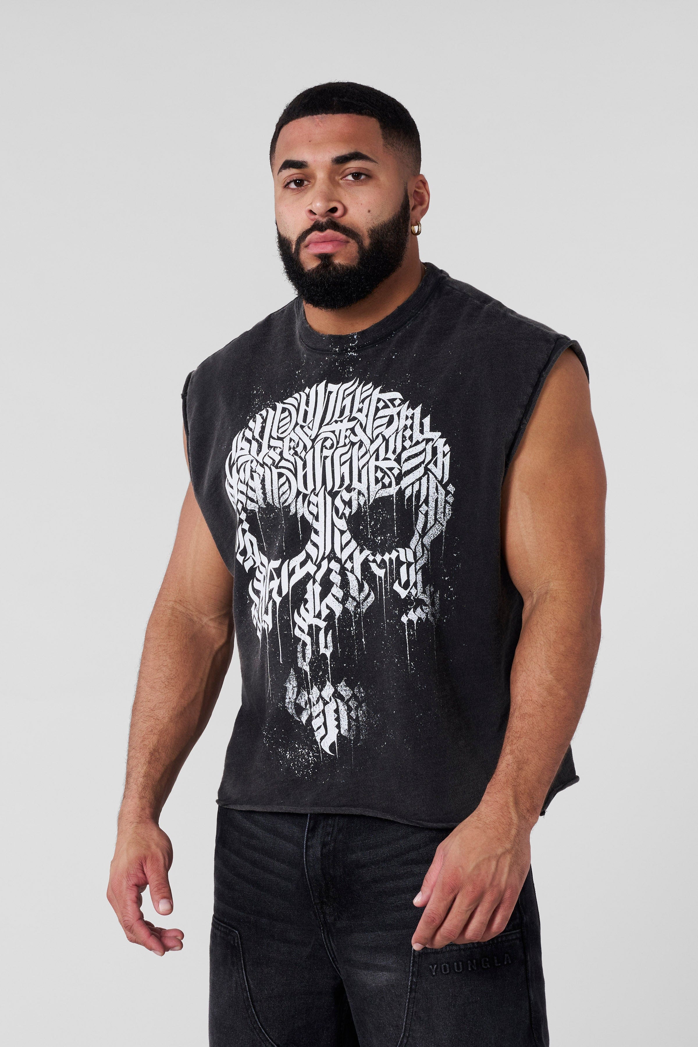 Male model wearing cut-off shirt layered over a tee for fall