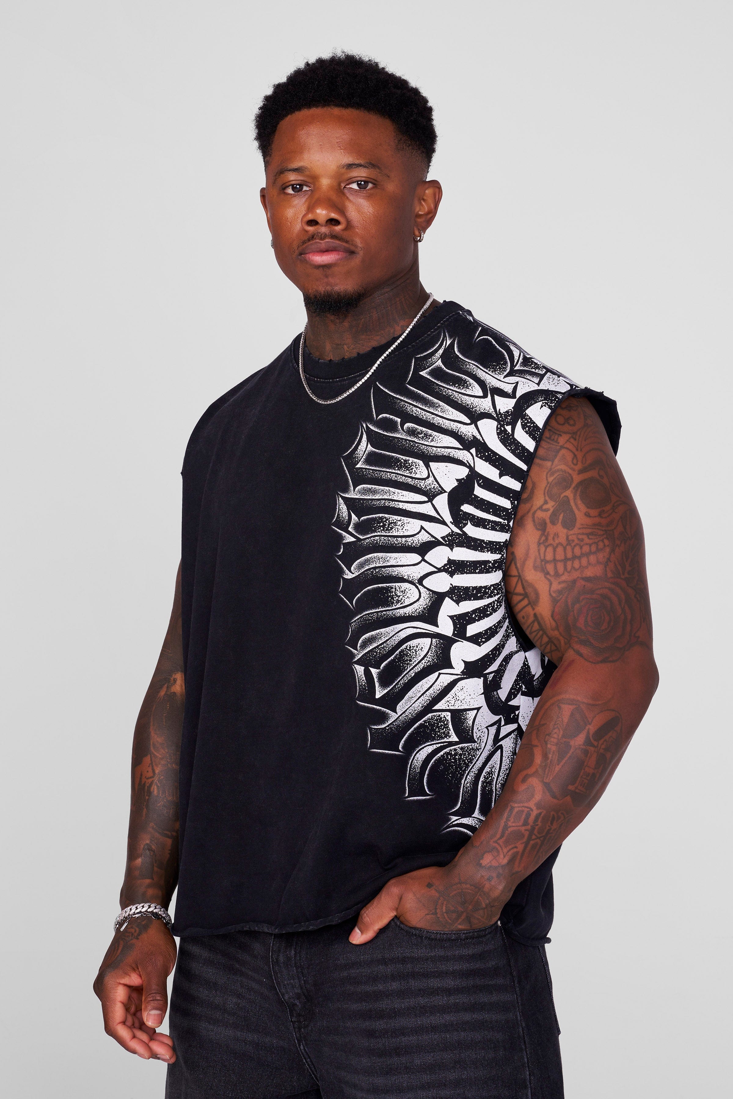 Front angle of muscle tank top worn by male model in urban setting.