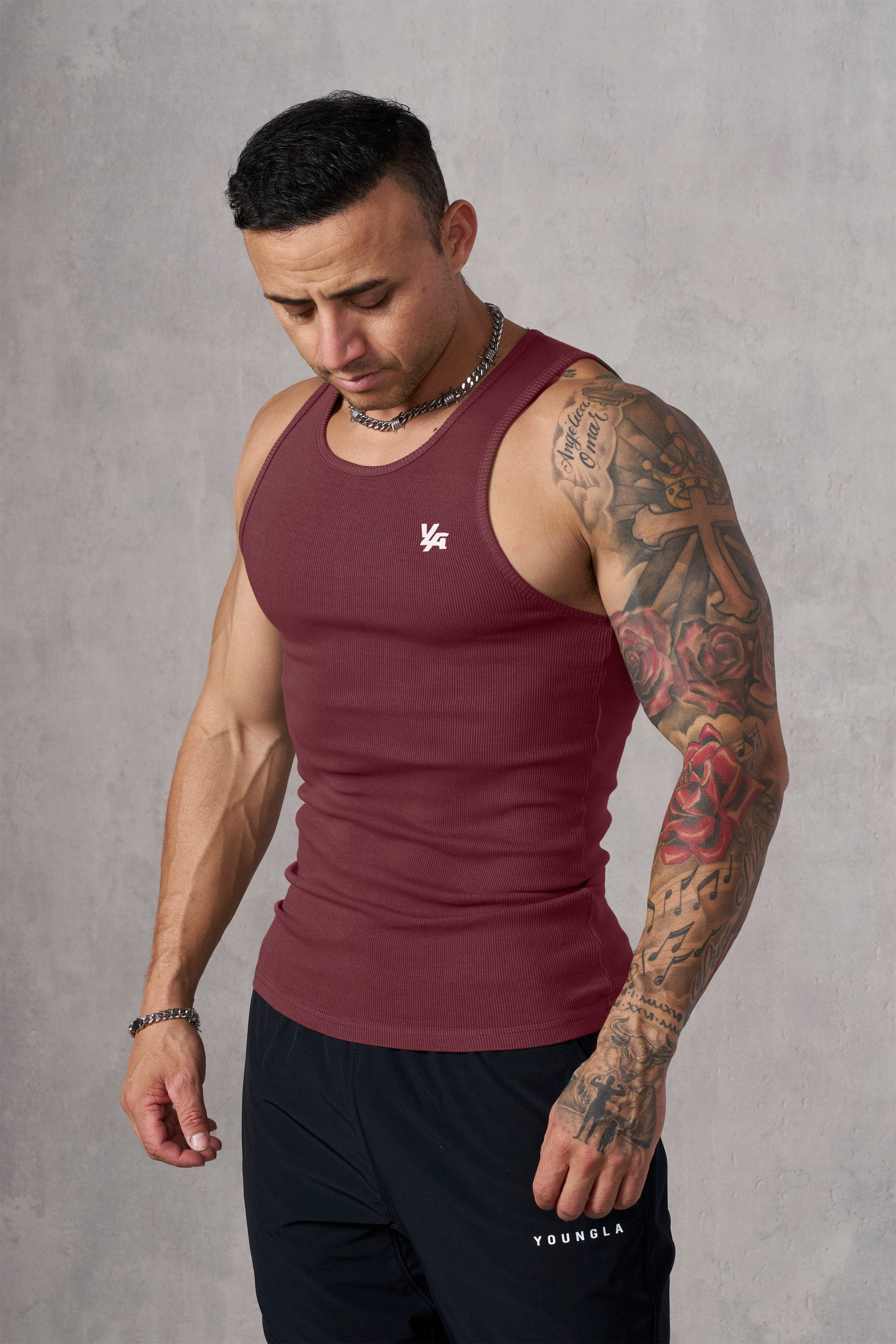 Front angle of white ribbed tank top worn casually outdoors.