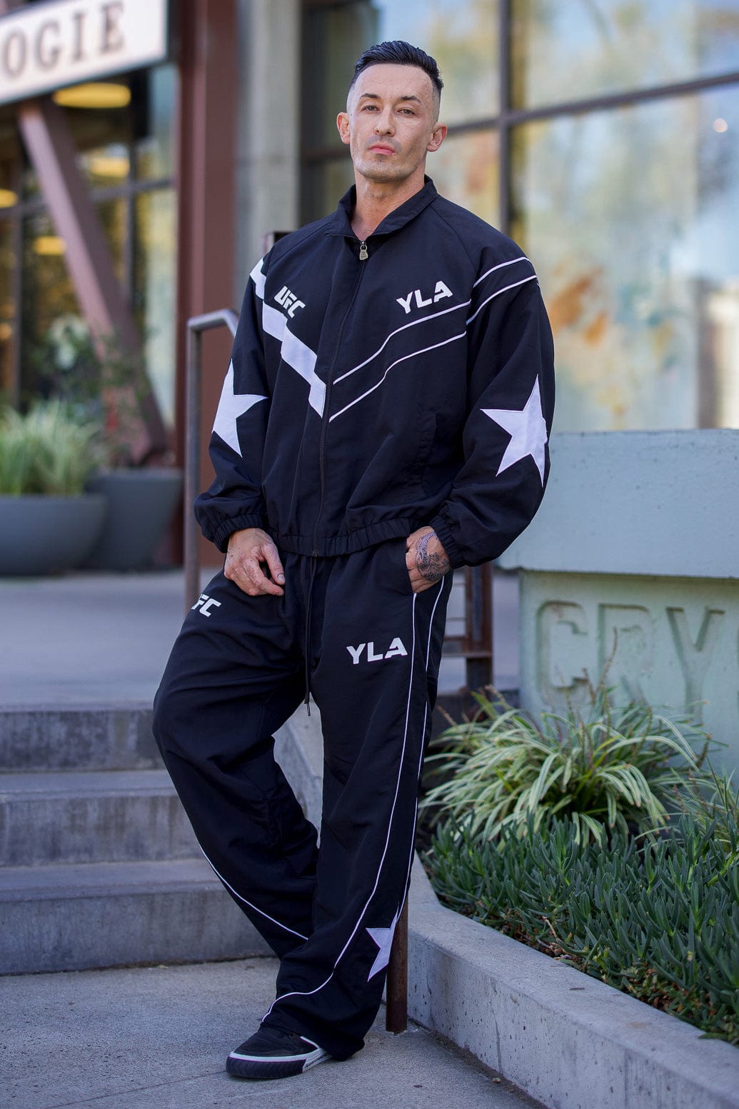Side view of the mens gray sports jacket, highlighting the star patch and piping details.