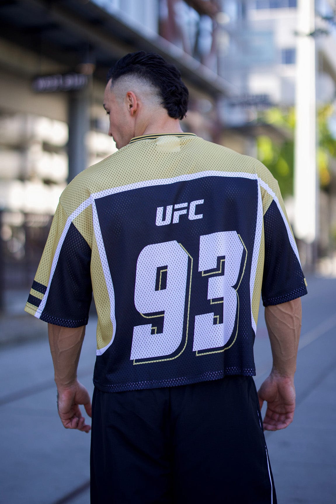 Close-up of UFC logo on the YoungLA jersey, highlighting its sporty design.