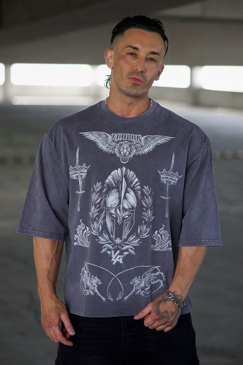 Front view of streetwear tee with royal battle graphics, worn in urban setting.
