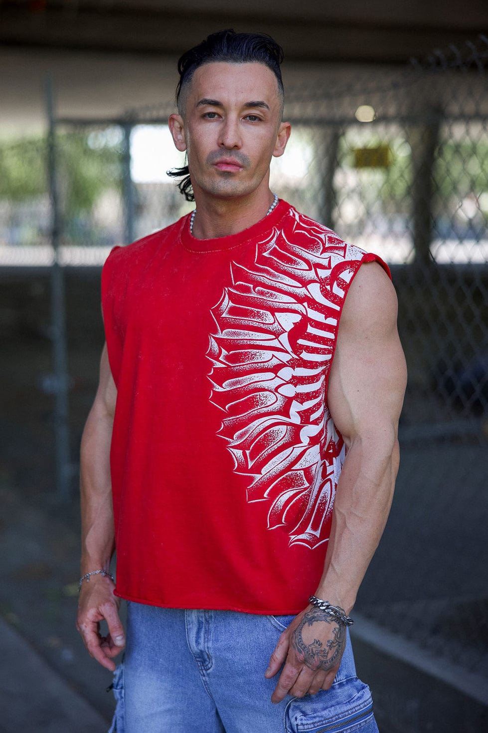 Close-up of cotton workout tee showing bold ink shoulder graphic detail.