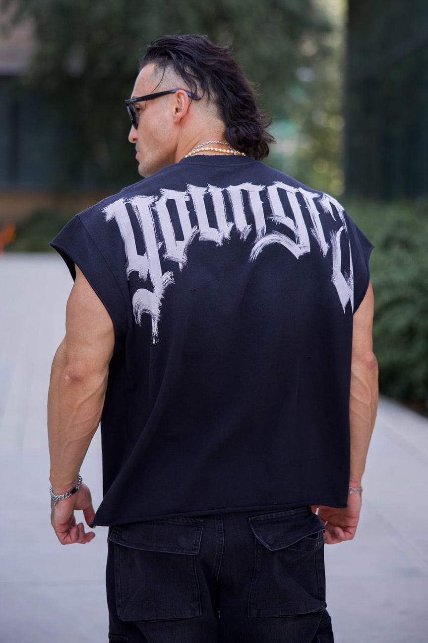 Man wearing gym tank top with drop shoulder detail in black finish