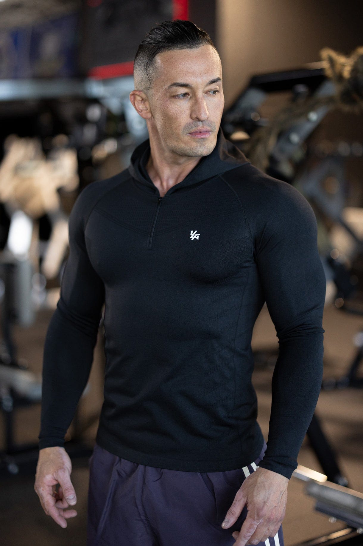 Front view of sleeveless workout hoodie worn by male model during a sunrise run.