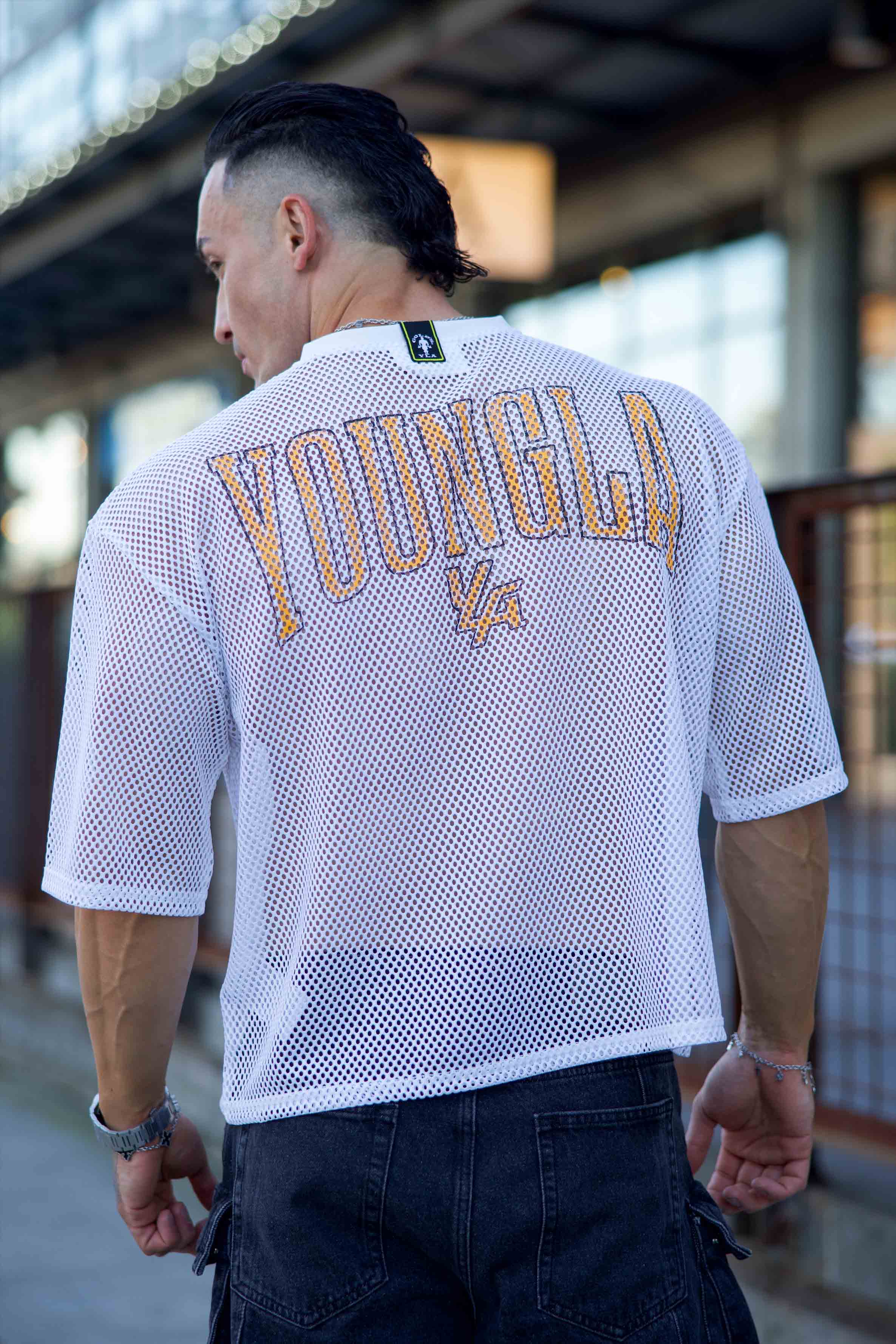 Side view showcasing the breathable mesh of the Black jersey, ideal for layering.