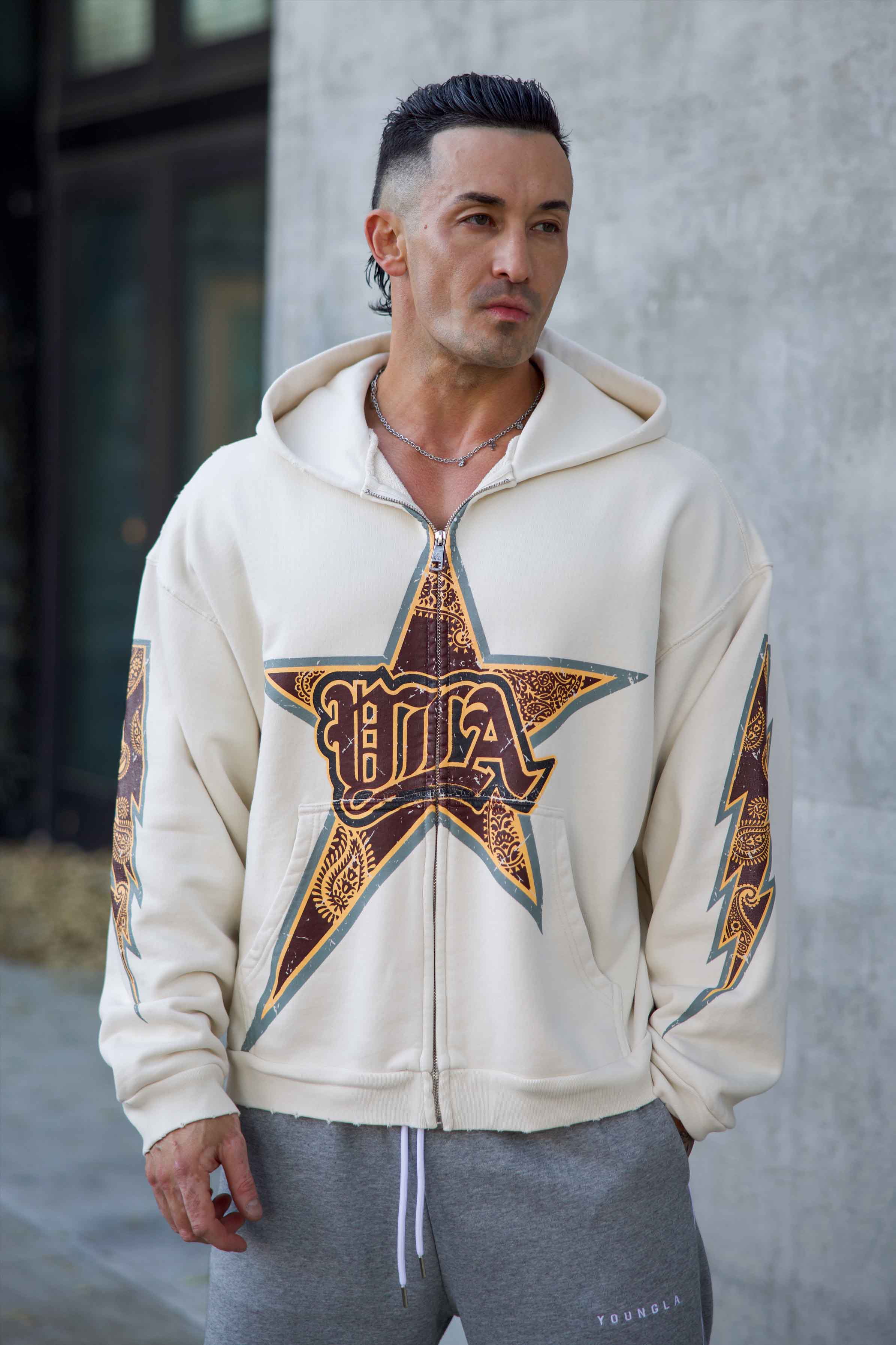 Front view of the Superstar Comfort Hoodie with star graphic and thunderbolt prints.
