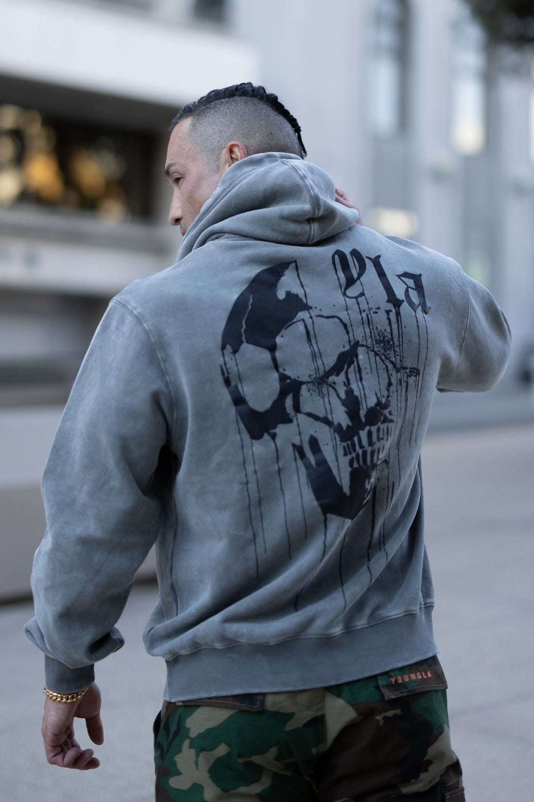 Side angle of the hoodie demonstrating its fit and washed vintage finish.