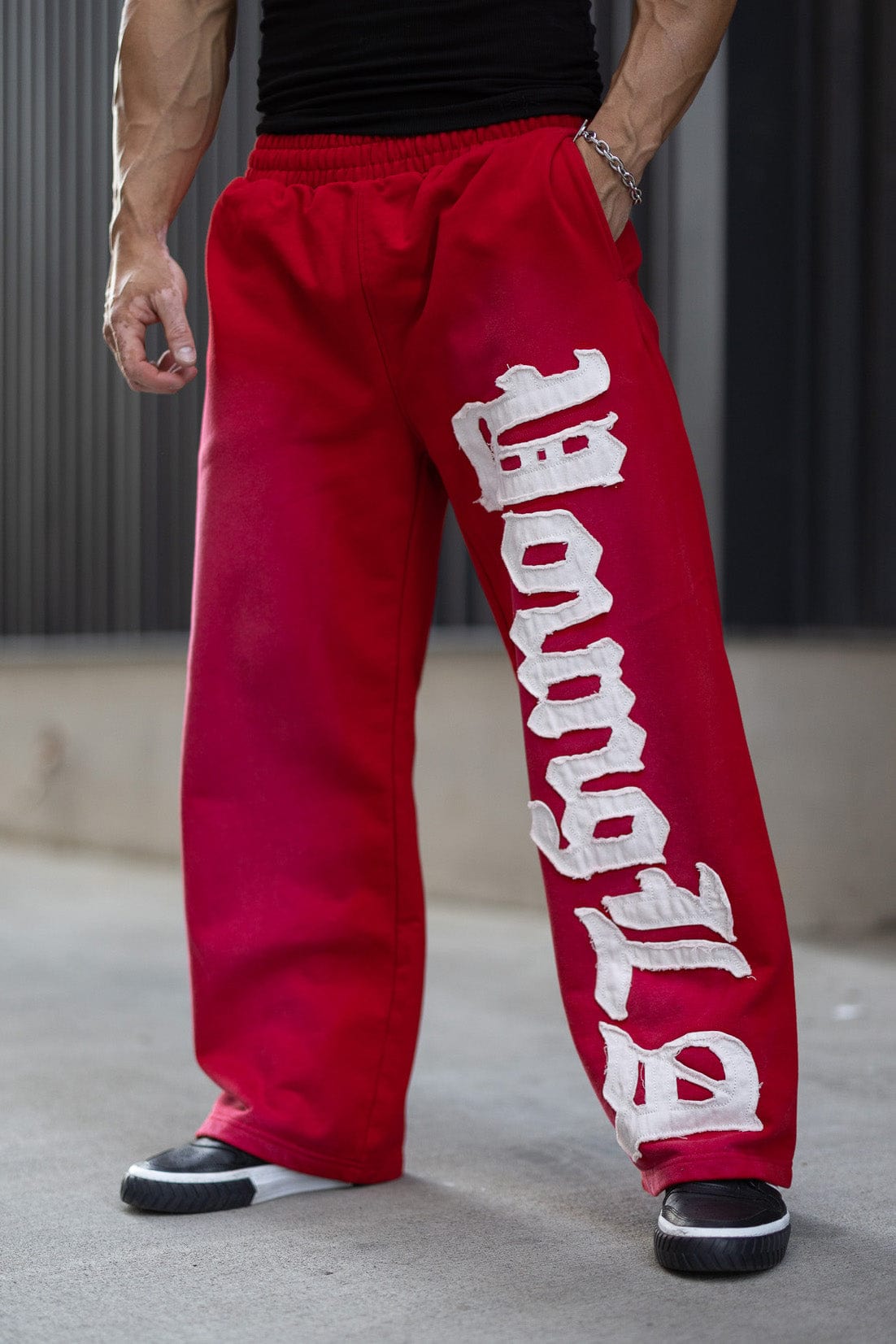 Front view of mens baggy sweatpants with logo patch