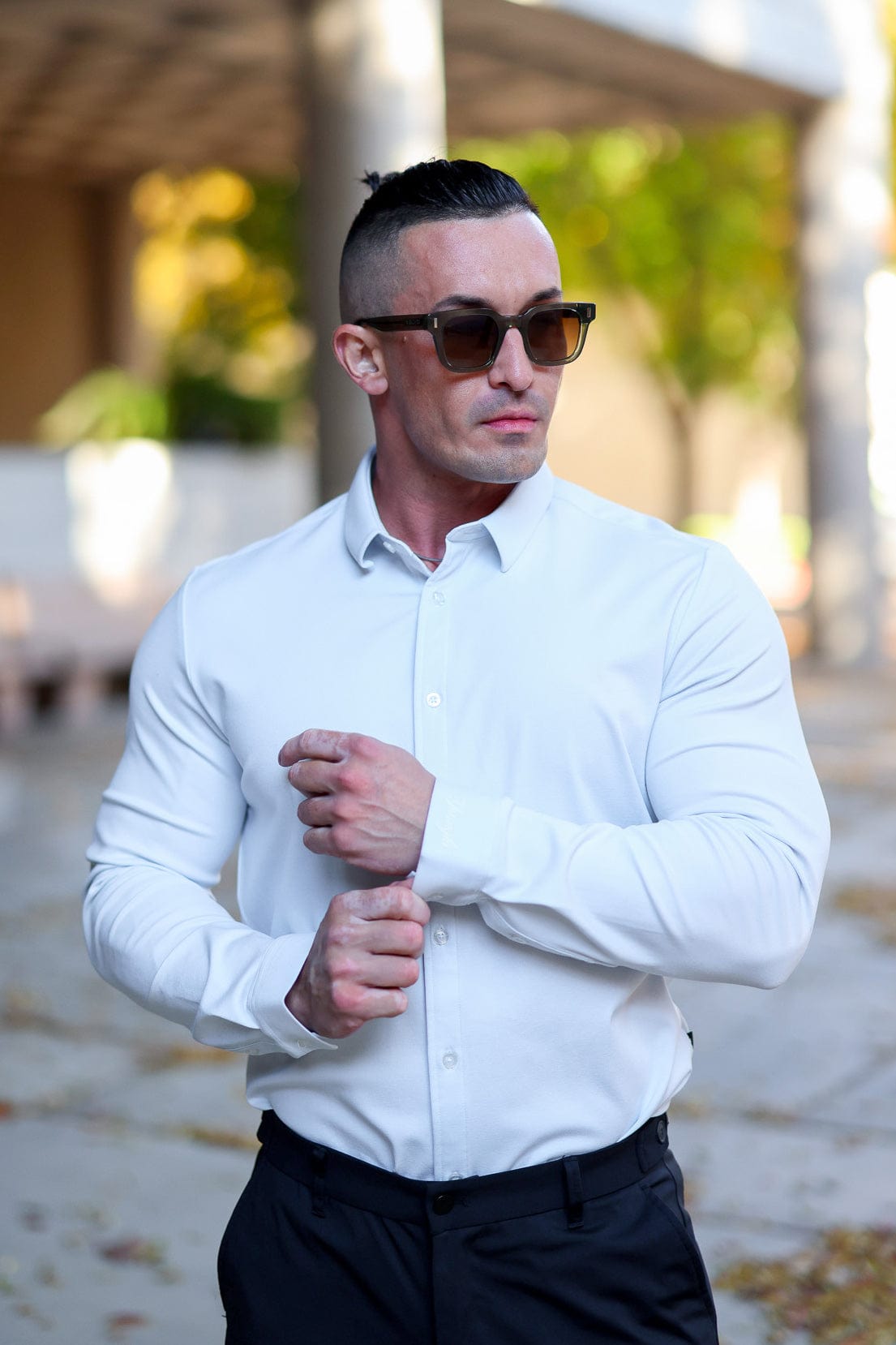 Detail of the shirts collar and buttons, highlighting its tailored design.