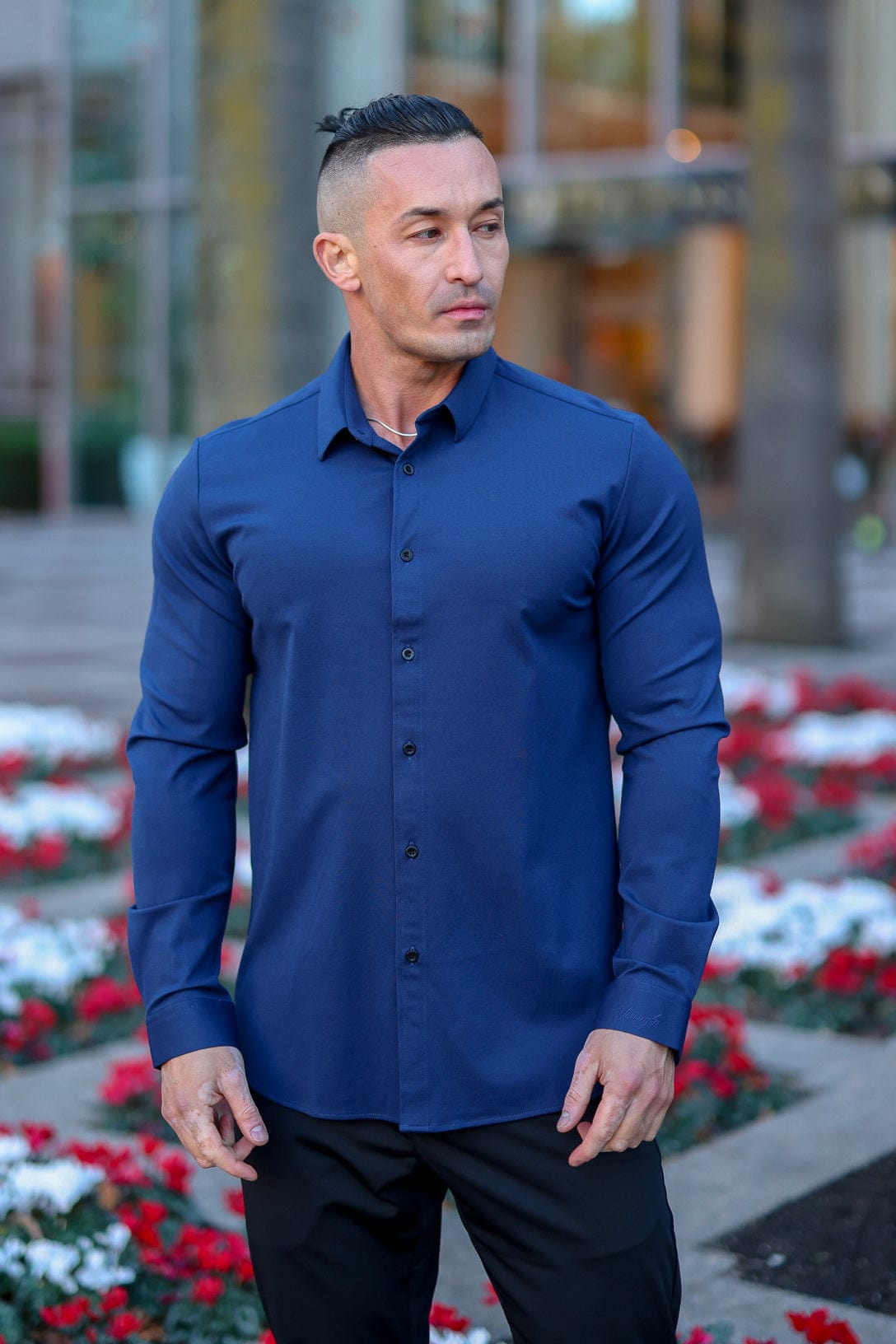 Model wearing a mens dress shirt paired with office tech pants.
