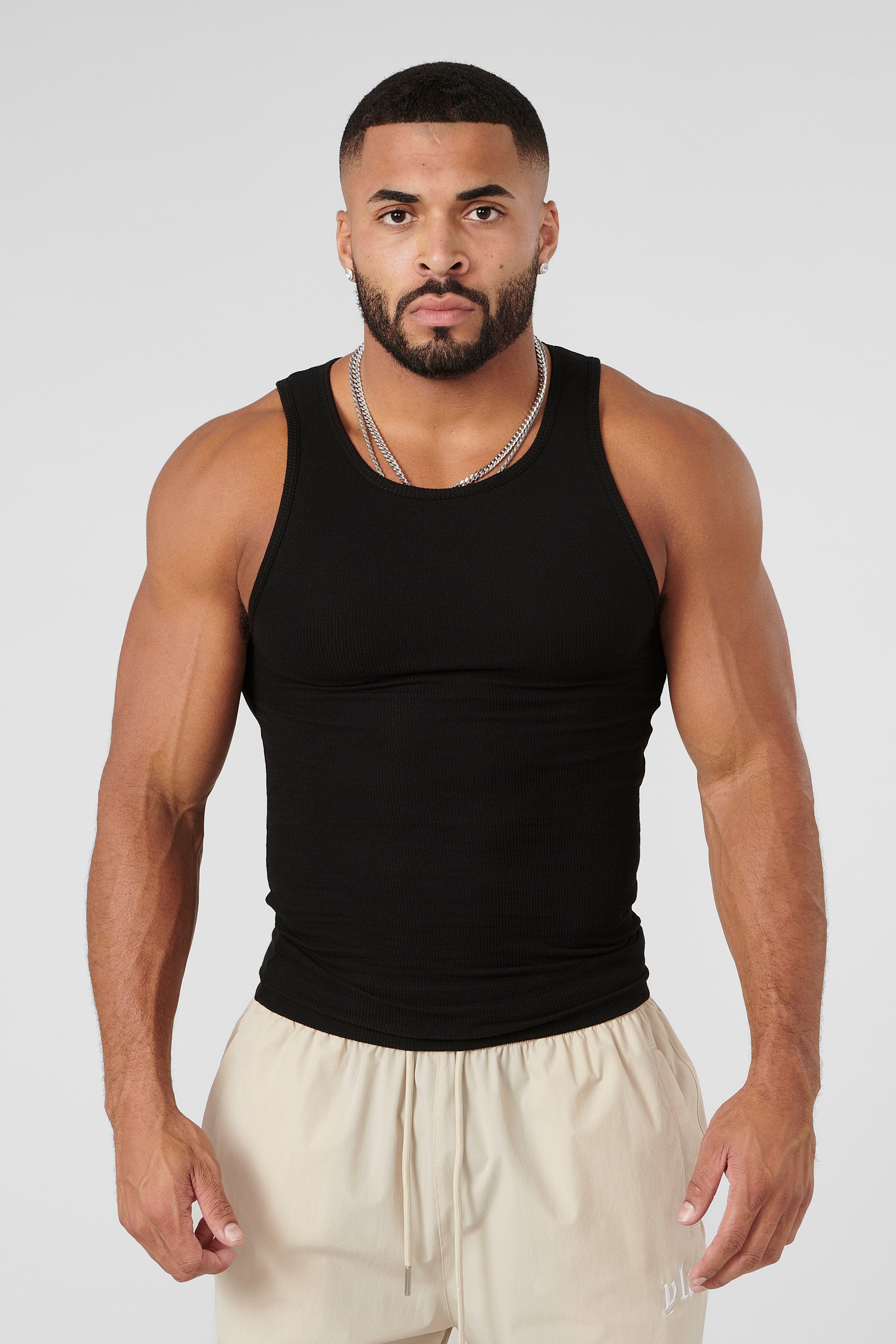 Side angle of compression shirts in oatmeal and heather grey on hanger