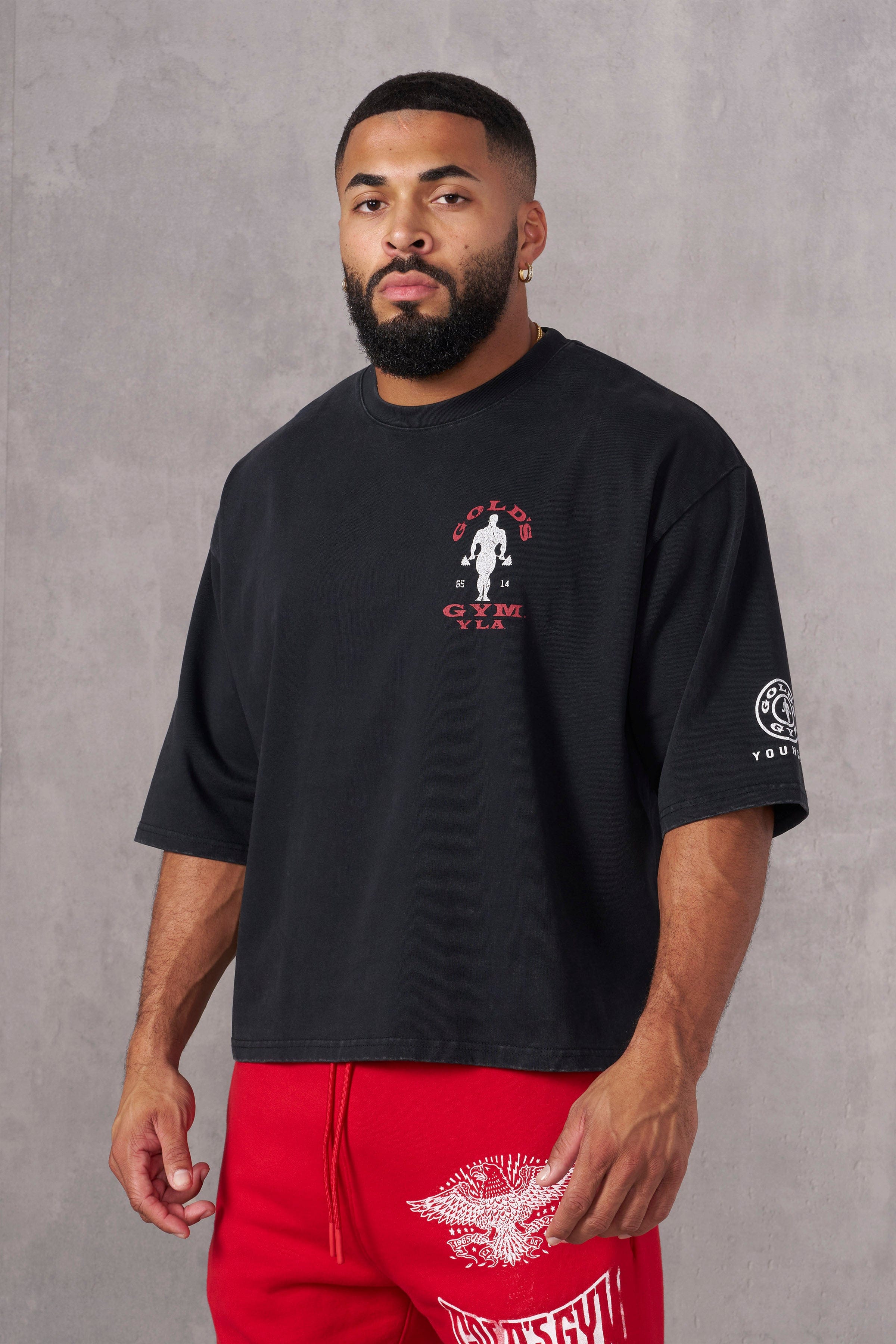 Close-up of distressed Golds Gym x YoungLA logo on back of heavyweight tee