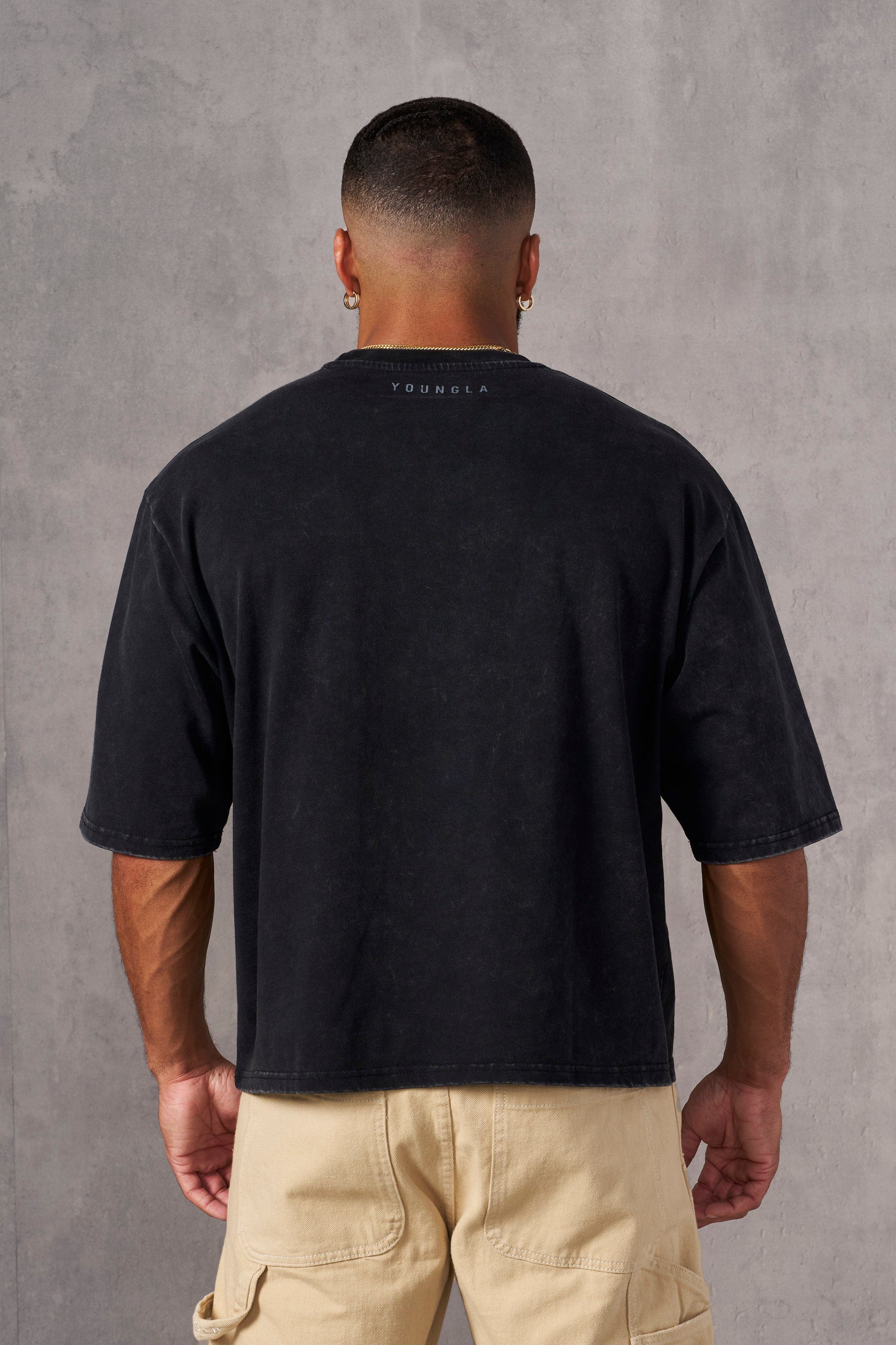 Close-up of fabric texture and muted grey print on acid-washed tees