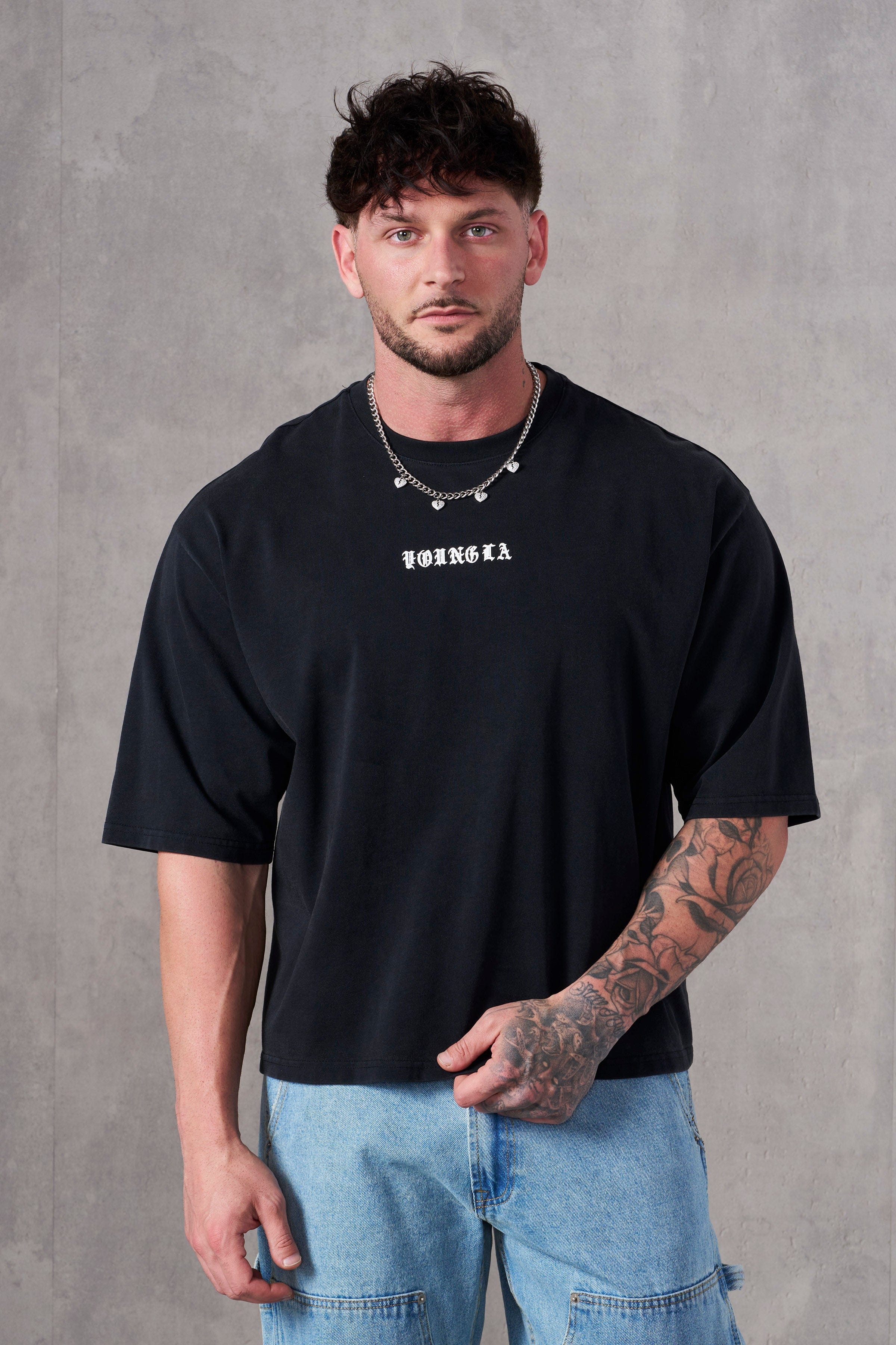 Acid wash tee in charcoal, unisex boxy fit, styled with jeans