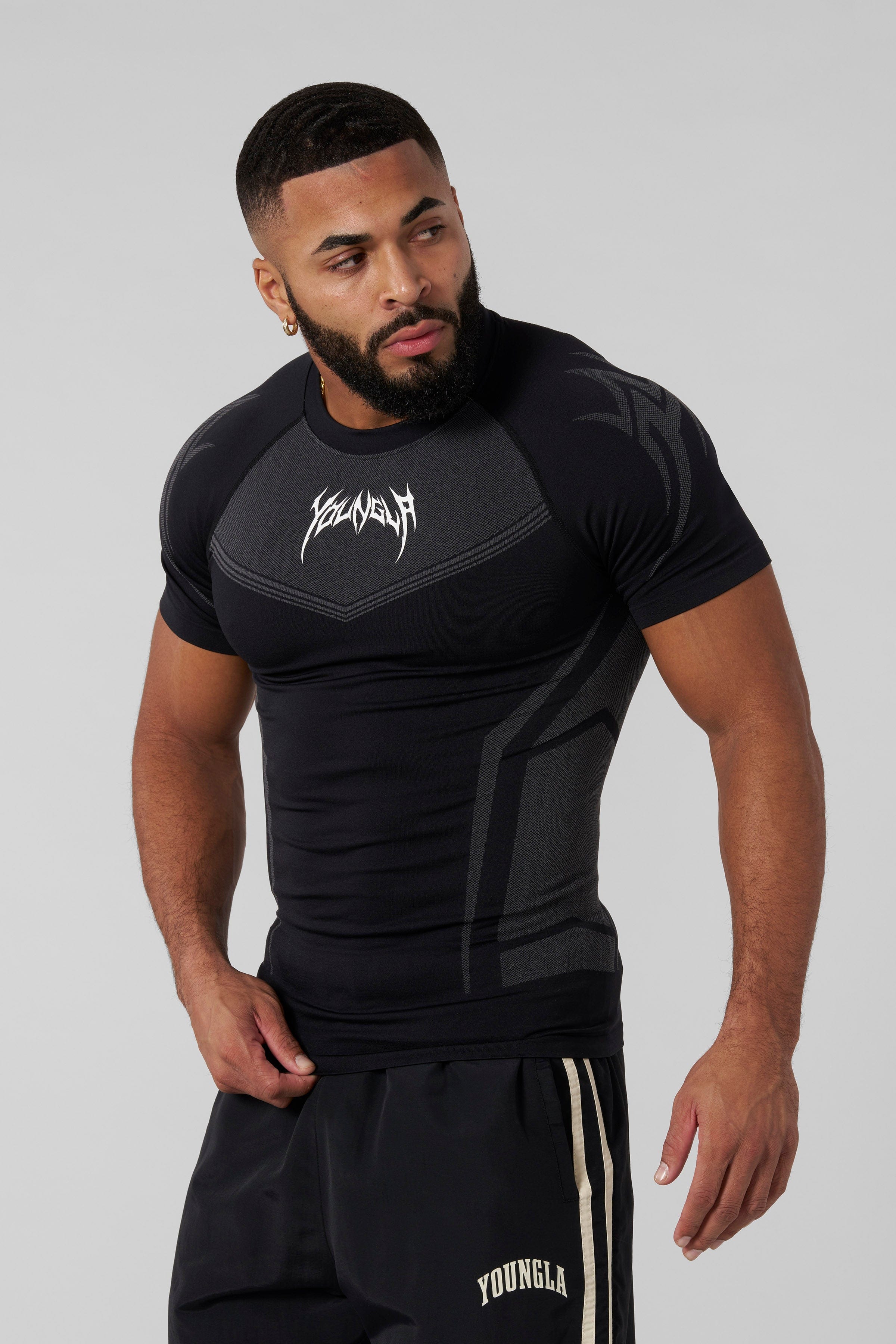 Front view of black compression shirt highlighting tribal shoulder design