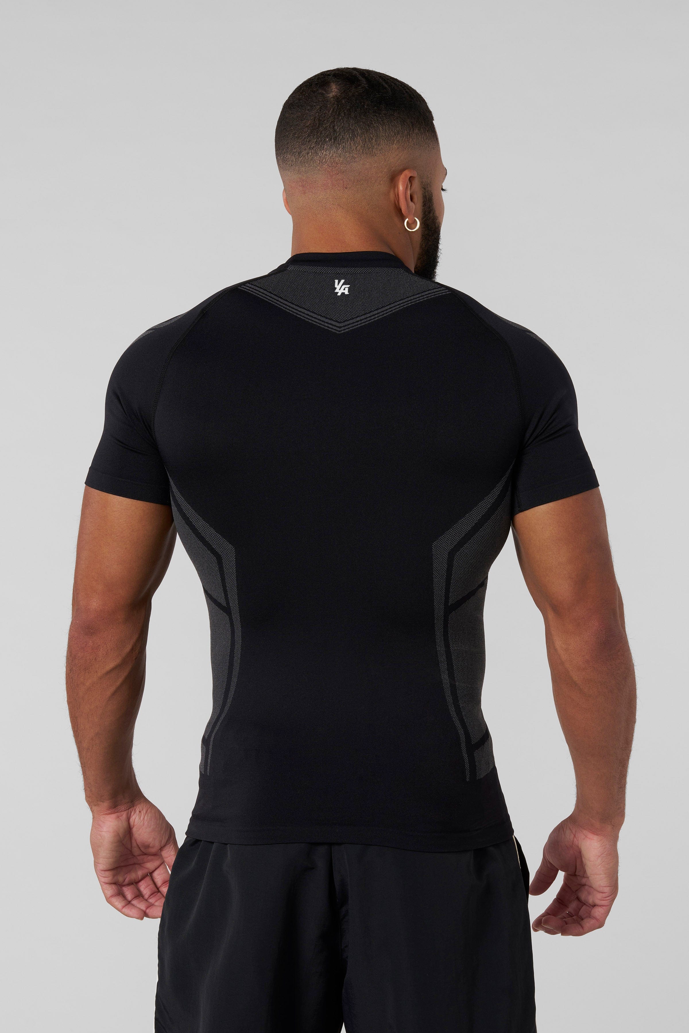 Front view of black compression shirt highlighting tribal shoulder design