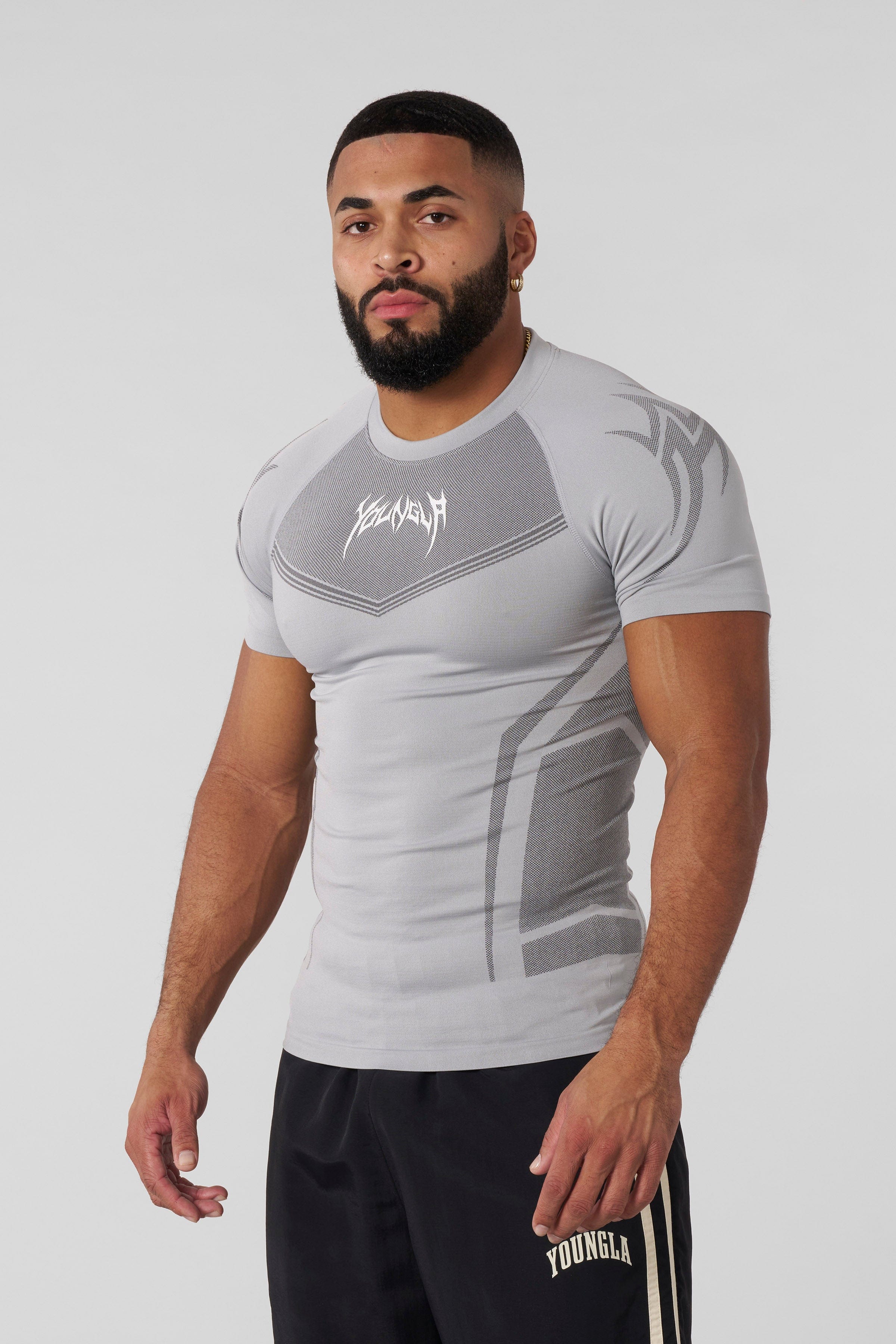 Front view of black compression shirt highlighting tribal shoulder design