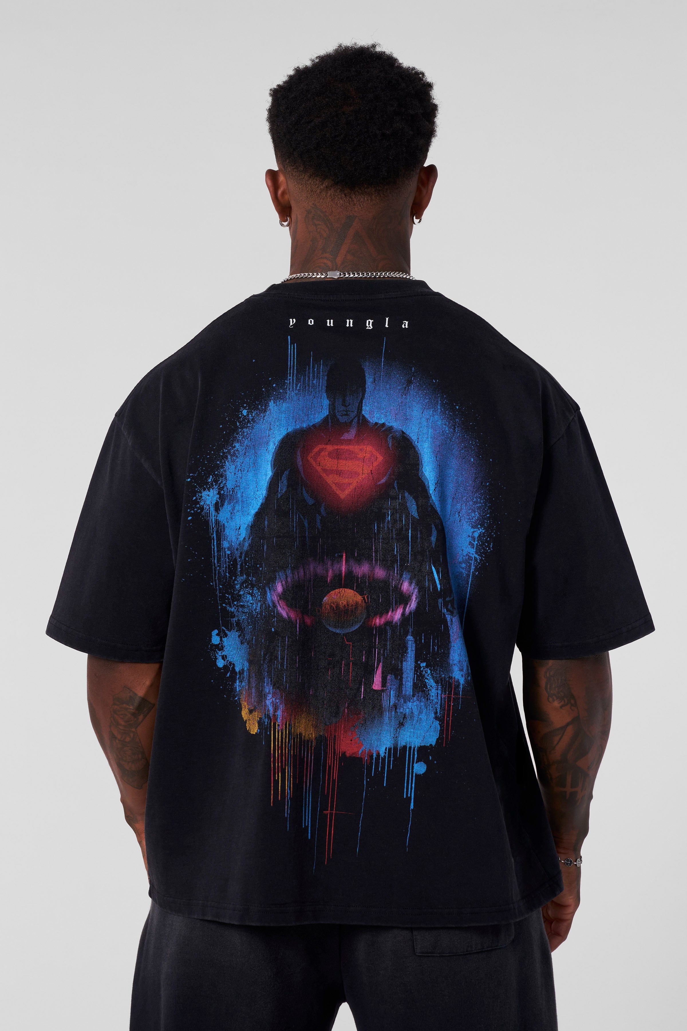 Model wearing the oversized Superman t-shirt in a casual setting.