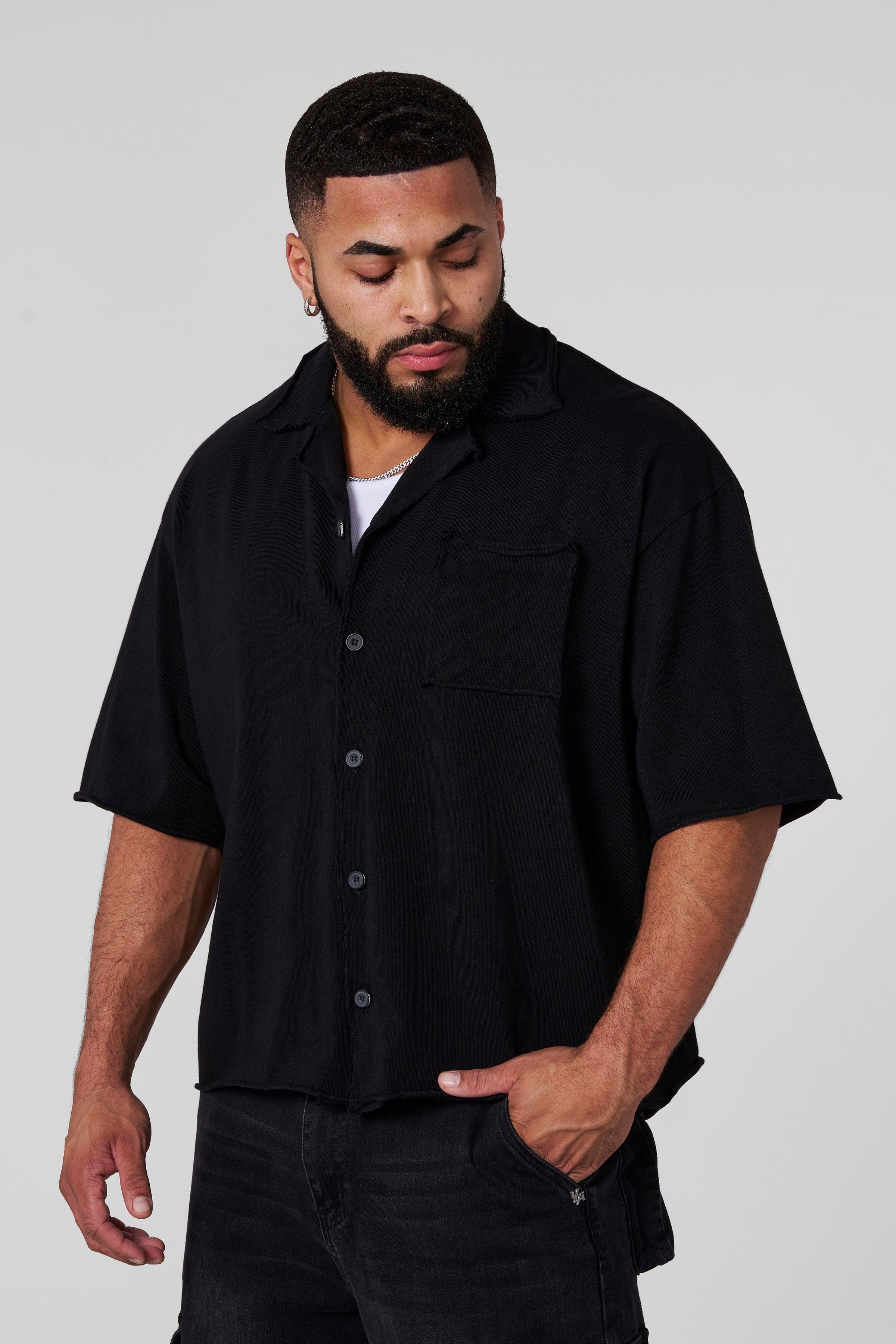 Model showcasing the oversized button up shirt in a casual street setting.