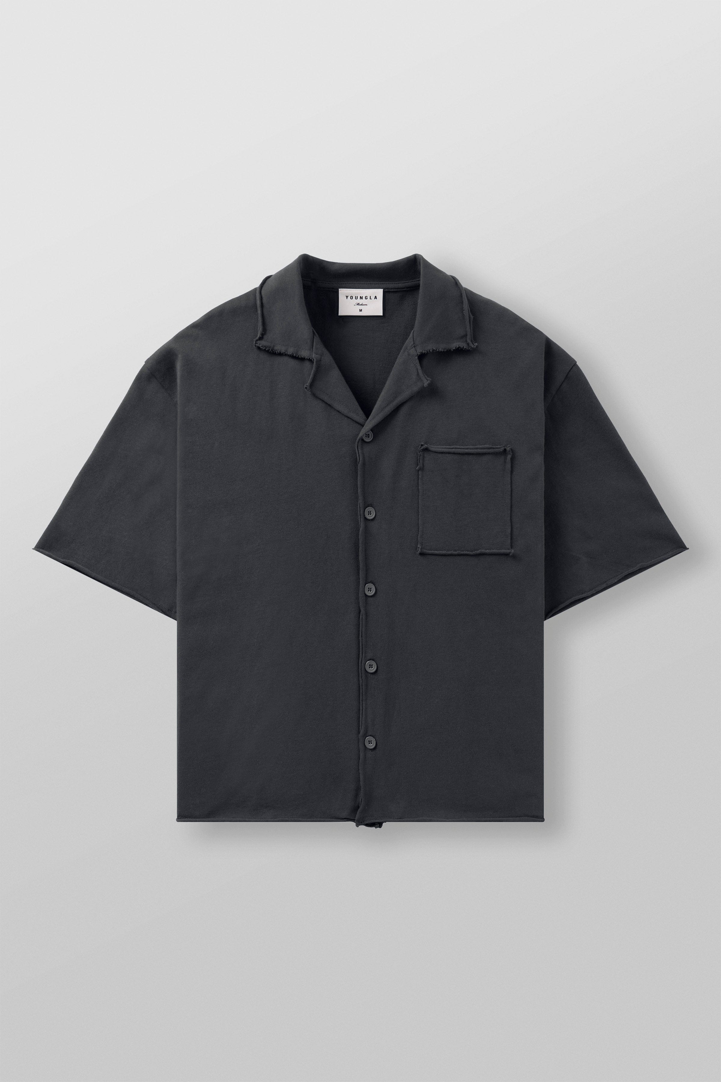 Close-up of the raw cut hems and fabric texture of the oversized button up shirt.