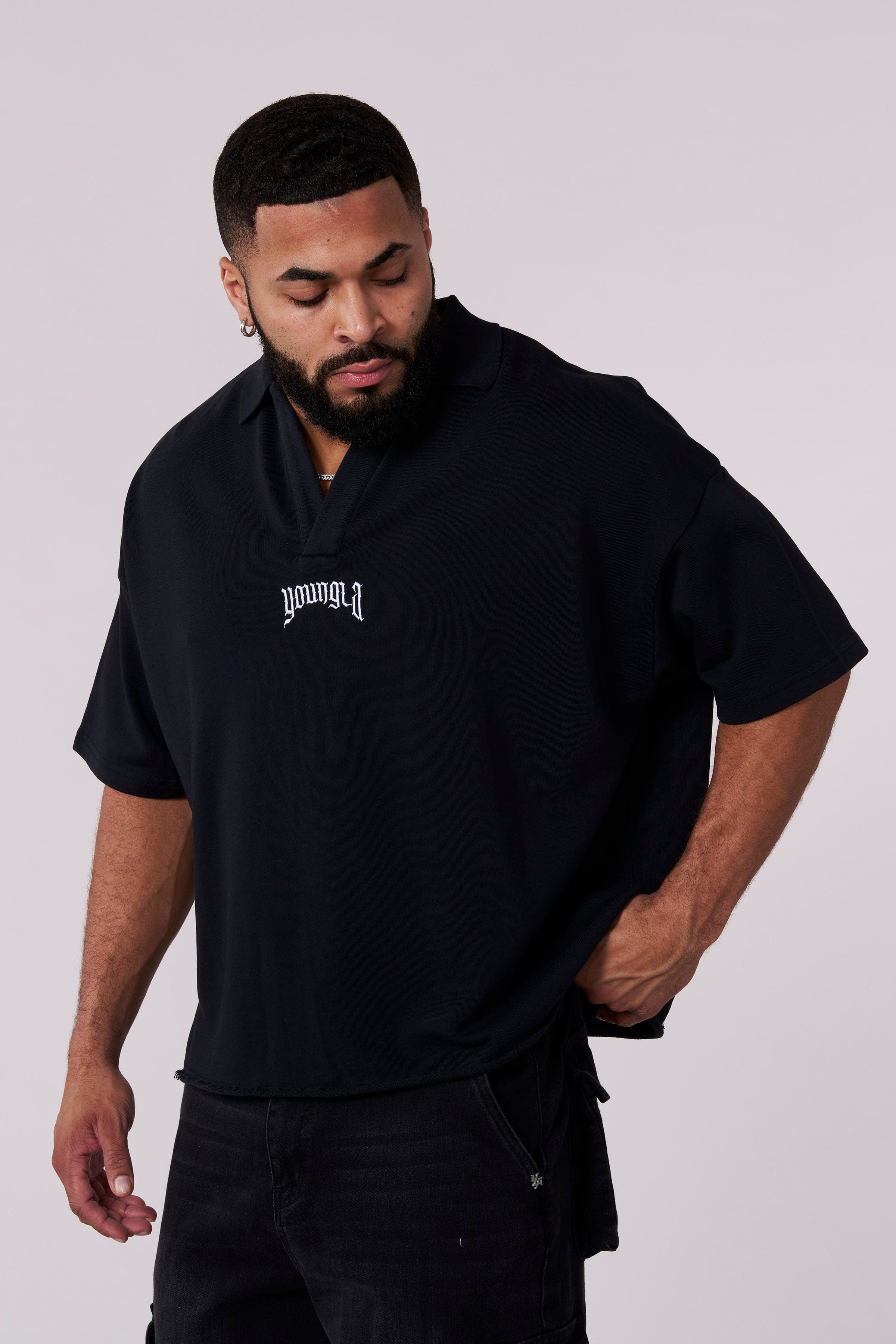 Side angle of mens long sleeve cotton polo shirt, relaxed fit