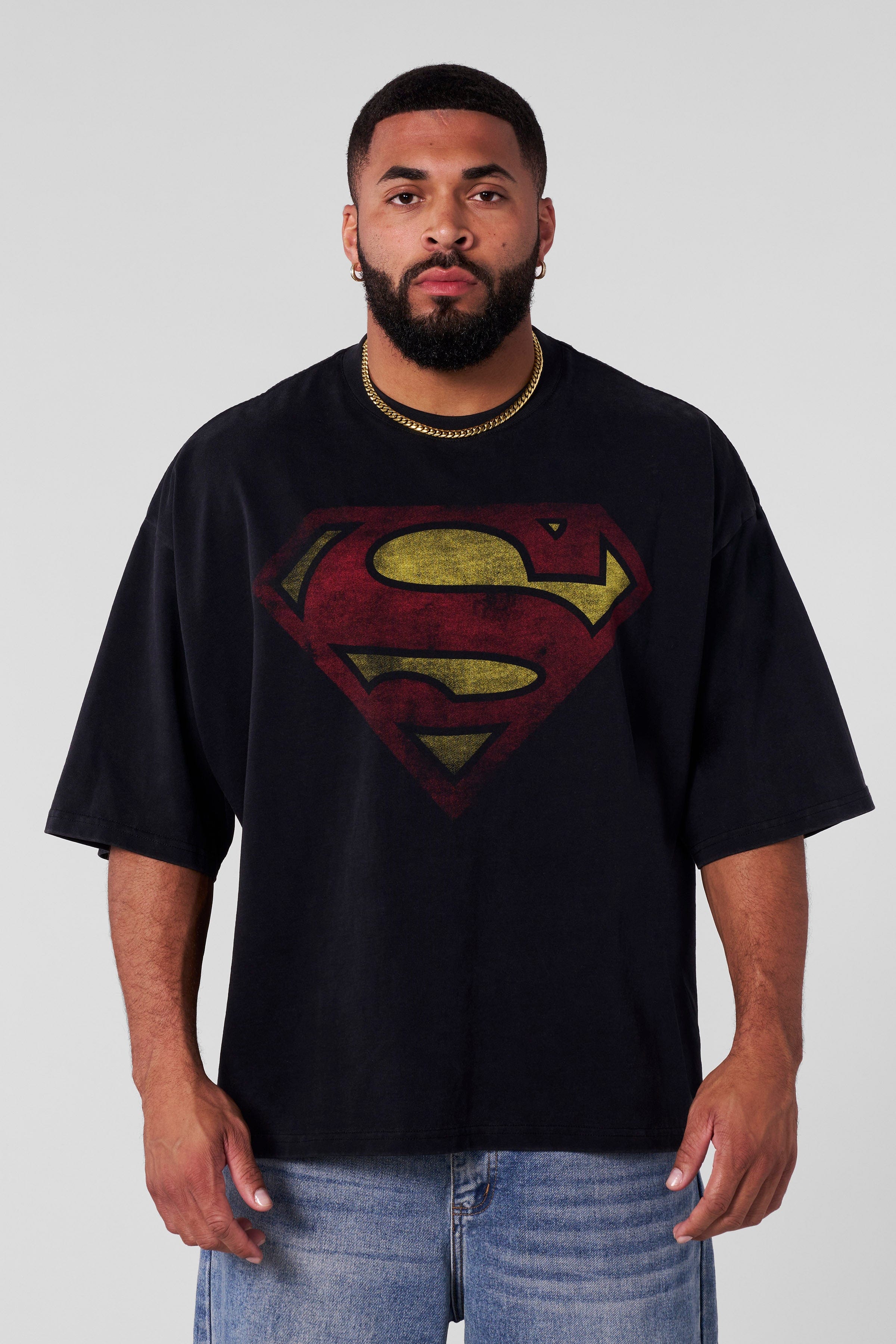Model wearing the superman logo t shirt showing oversized fit and design details