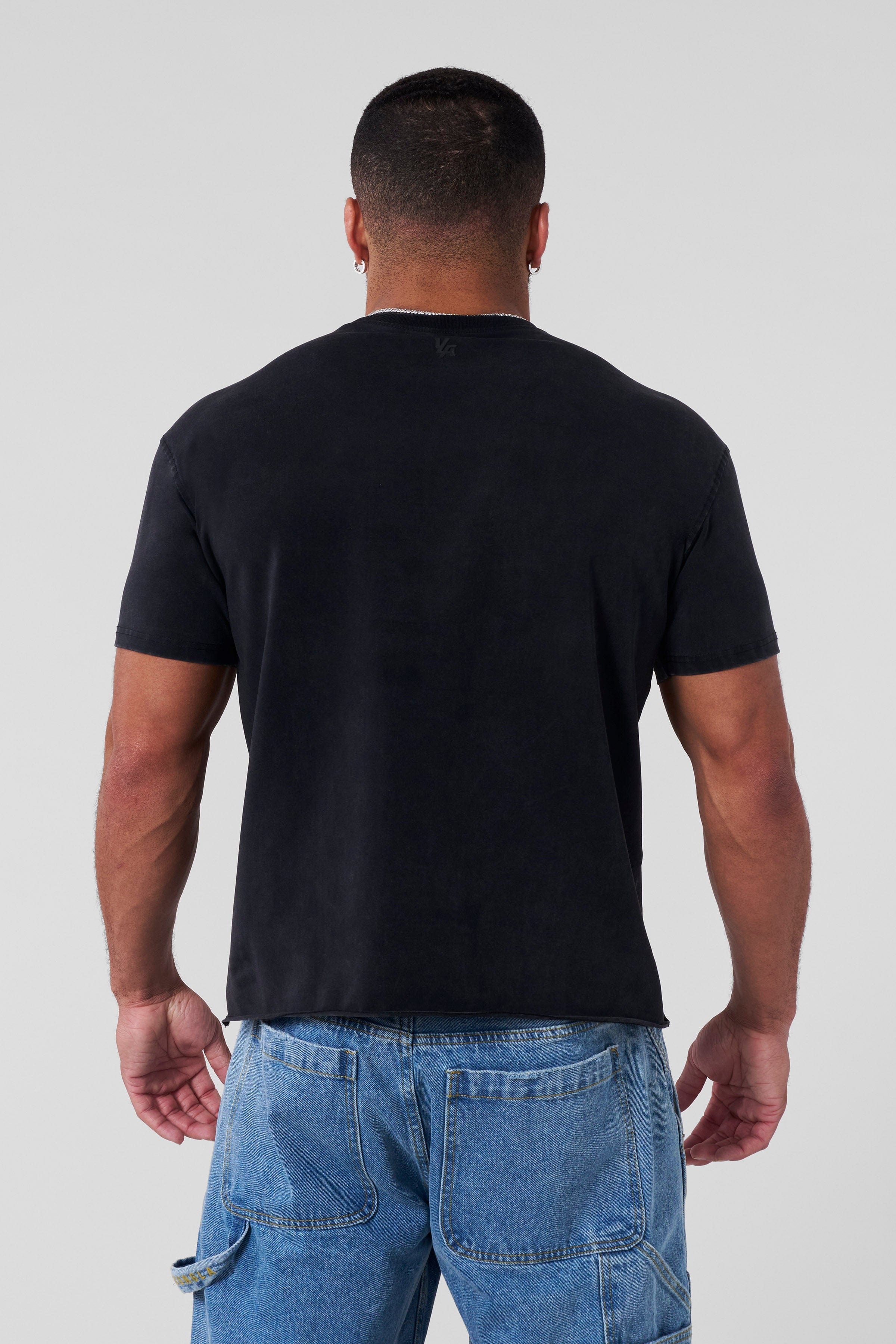 Front view of the oversized cropped tee on a model in a casual setting.
