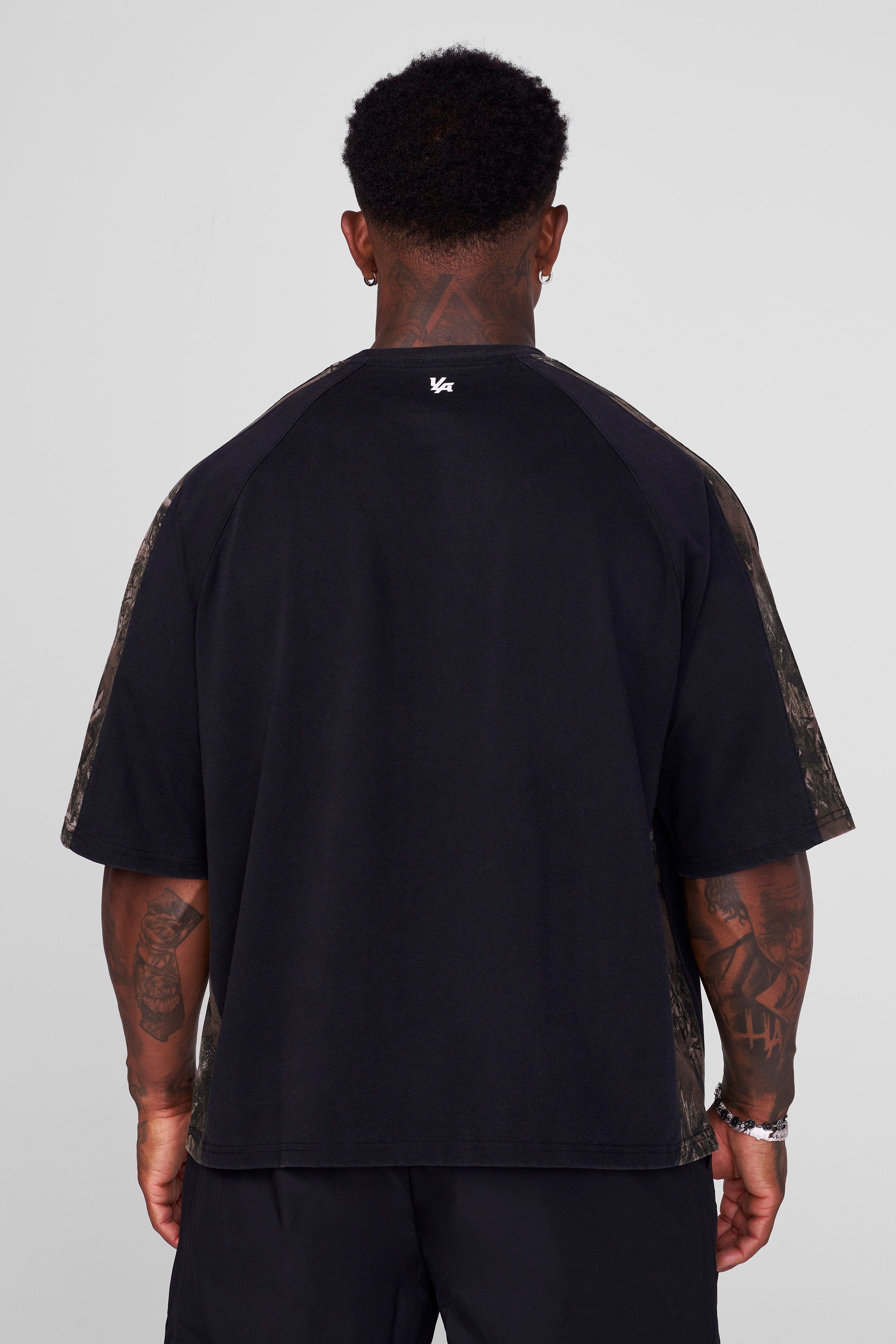 Close-up of the raglan paneling on the oversized t-shirt.