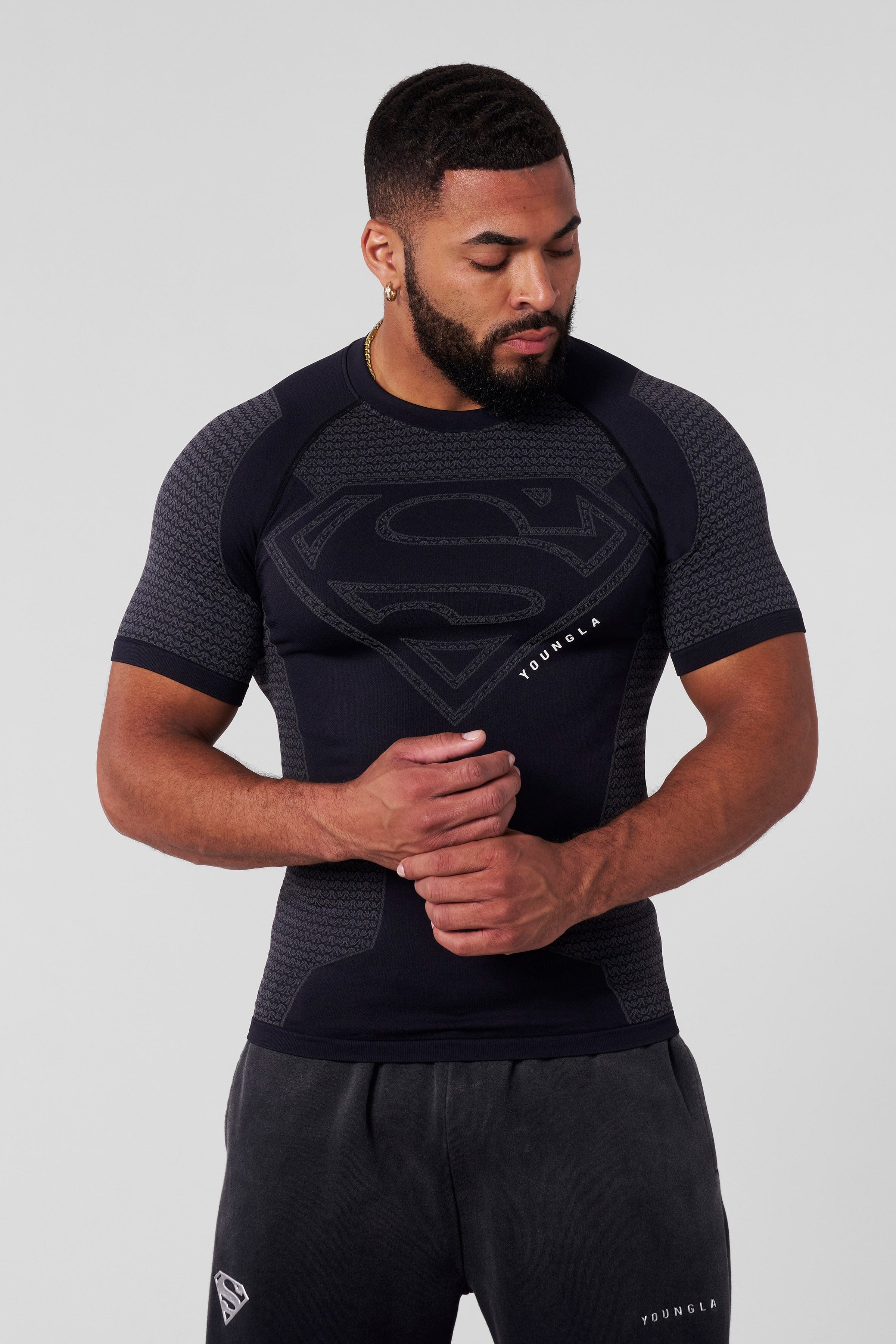Athlete wearing the compression tee during a workout, highlighting flexibility.